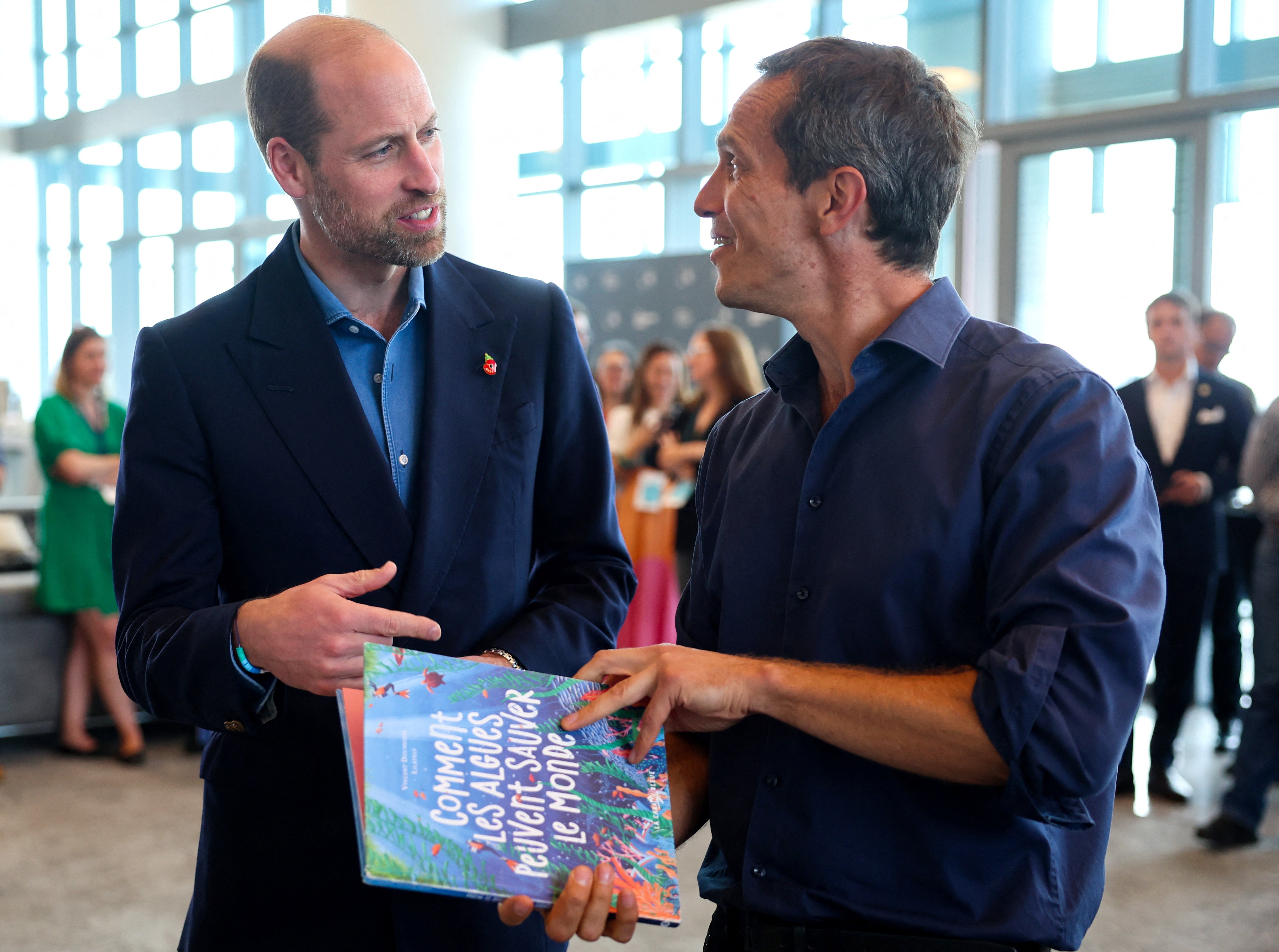 Prince William, Prince of Wales speaks with a business representative during a visit to meet seaweed businesses from the region to celebrate local innovation and to learn about the potential for it to repair and regenerate the planet at Portside Tower