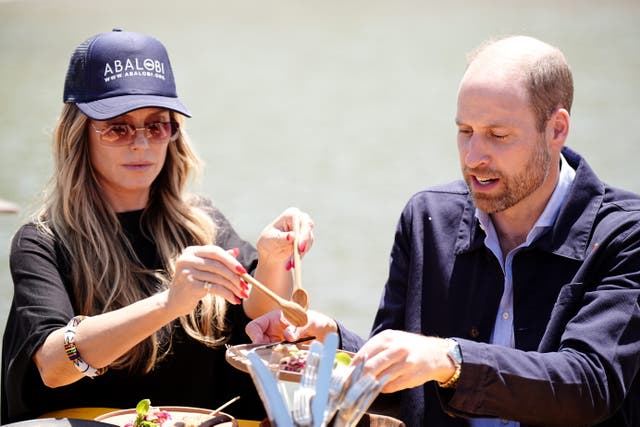 The Prince of Wales with Heidi Klum during his visit to meet local fishermen in Kalk Bay Harbour, Cape Town, to highlight the contributions of 2023 Earthshot finalist Abalobi, on the last day of his visit to South Africa (Aaron Chown/PA)