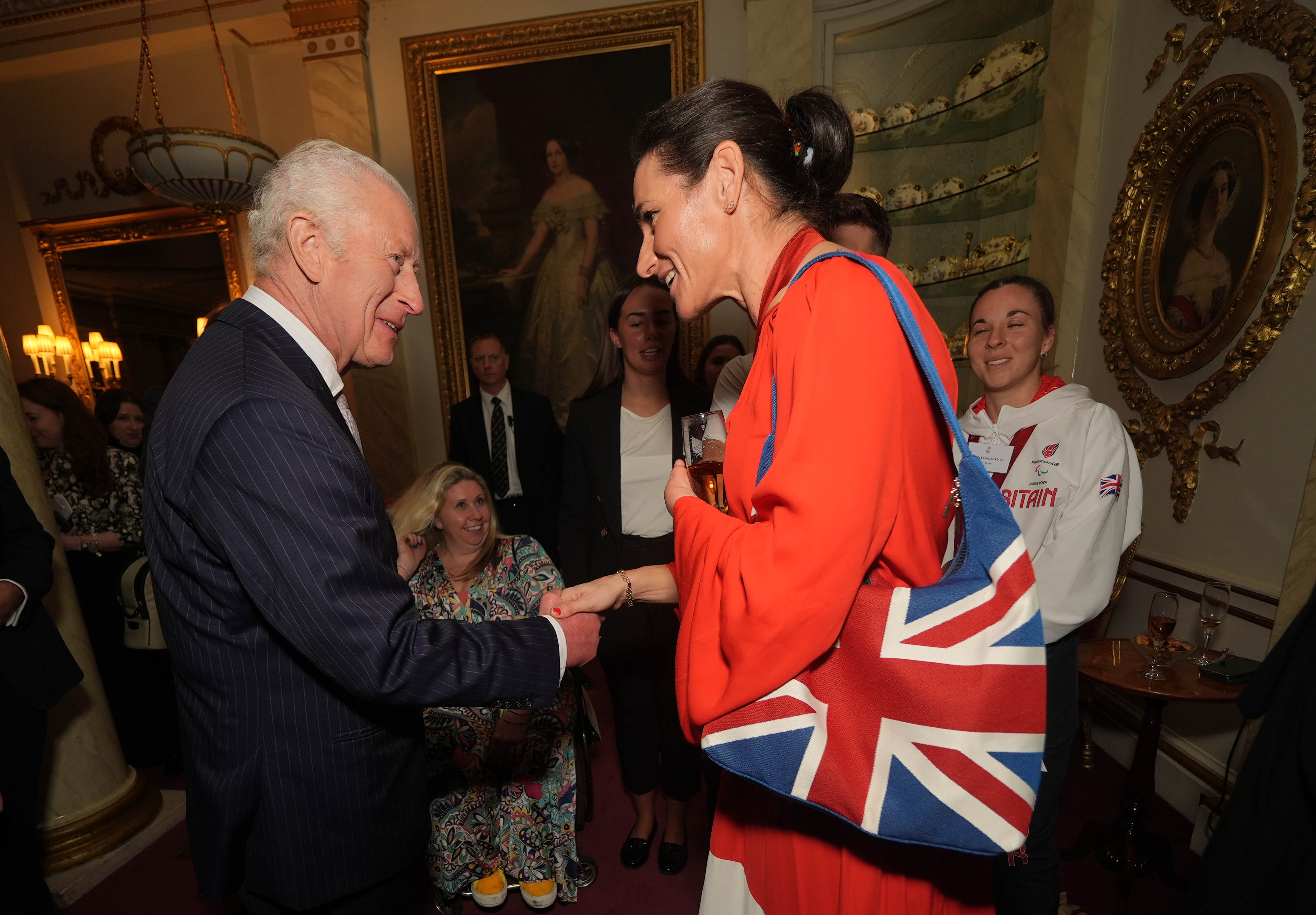 King Charles III talking to Dame Sarah Storey as he holds a reception for medallists from the Paris 2024 Olympic and Paris