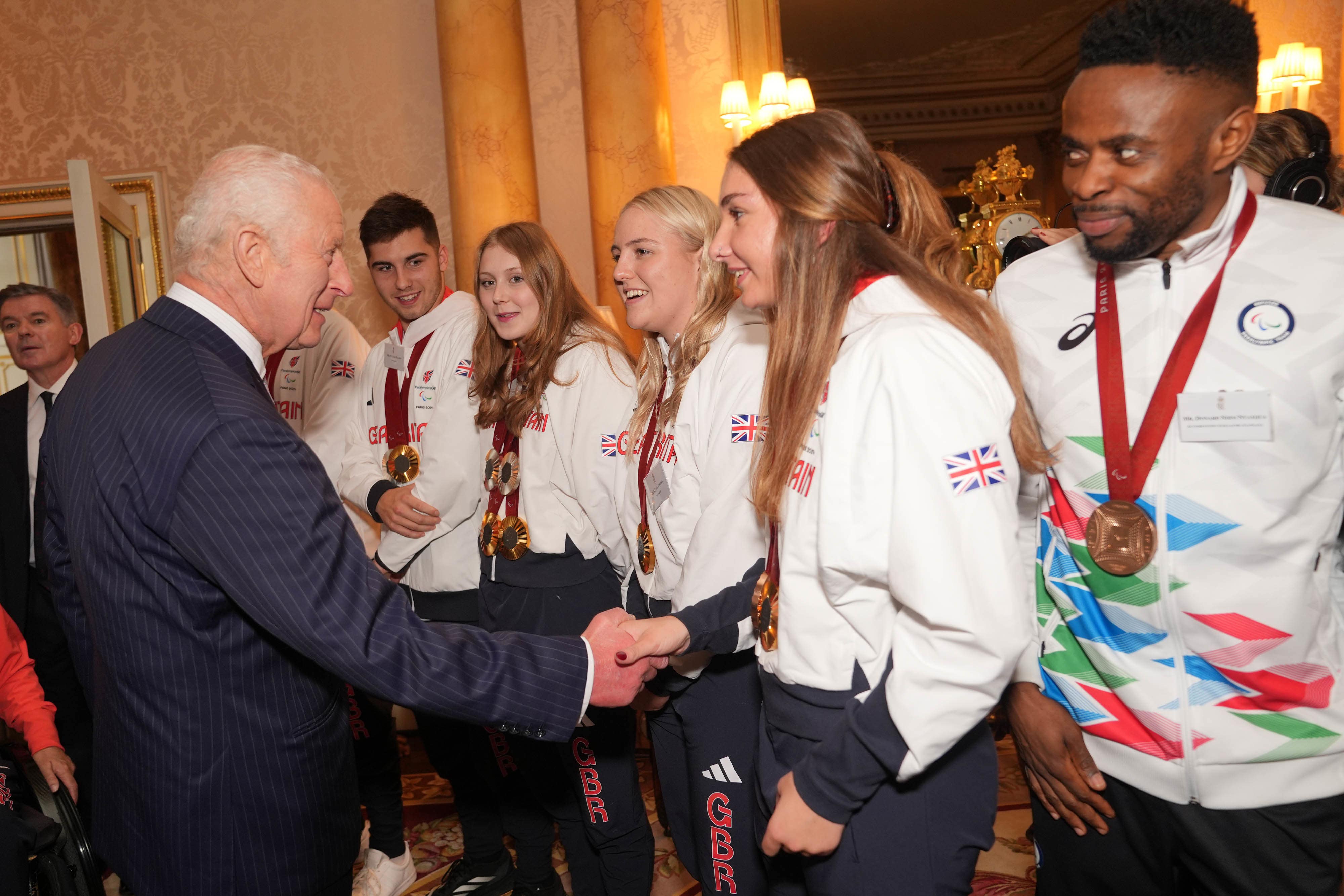 The King talking to guests as he holds a reception for medallists (Yui Mok/PA)