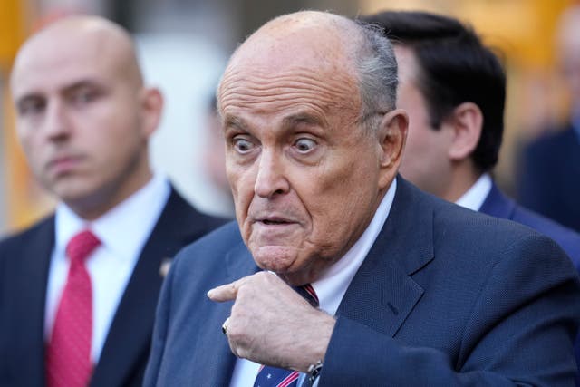 <p>Rudy Giuliani speaks to reporters after leaving a federal courtroom in New York City on November 7</p>