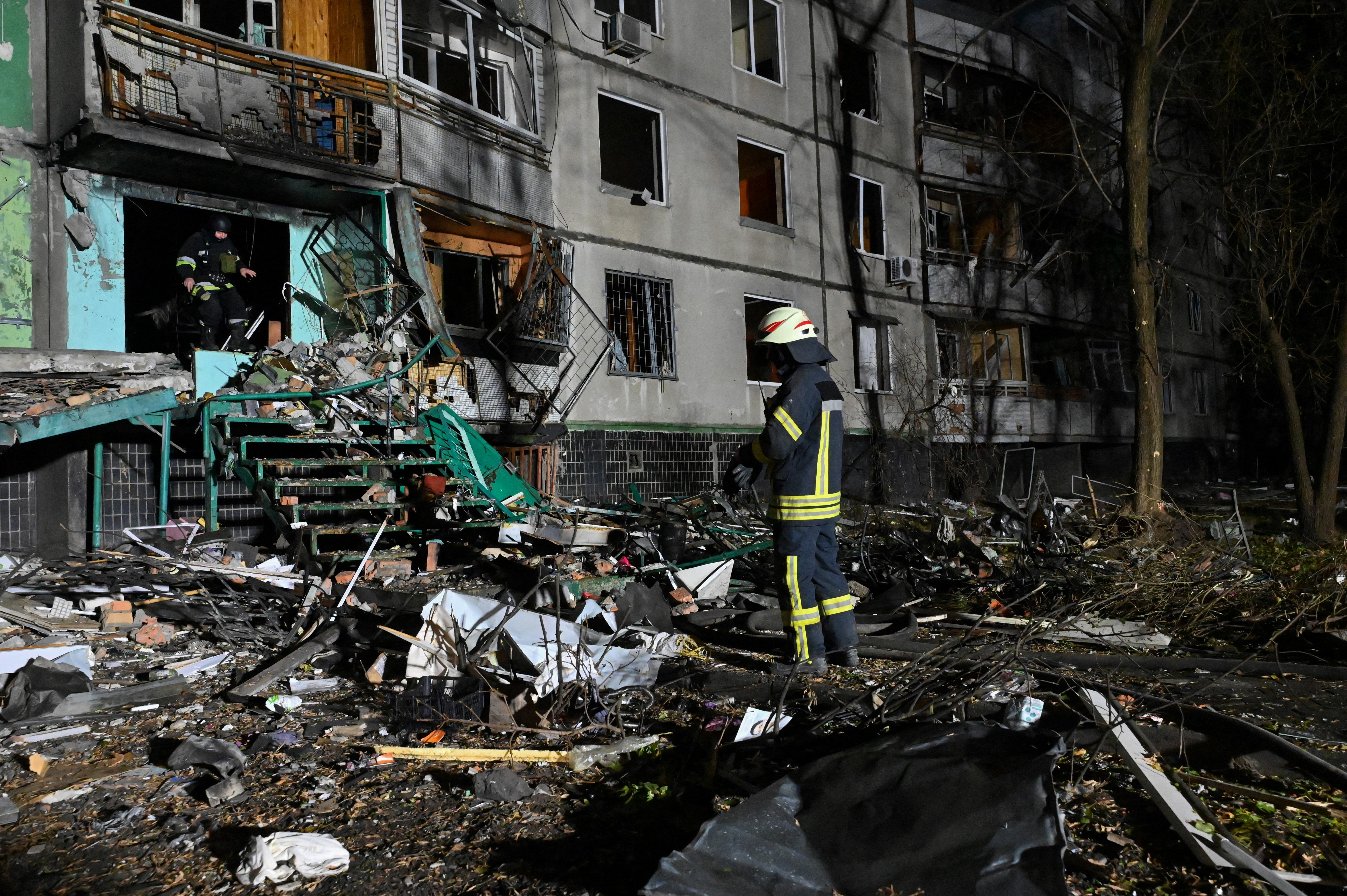 Rescuers of the State Emergency Service of Ukraine work in a multi-story building, damaged after an airstrike in Kharkiv on 8 November 2024