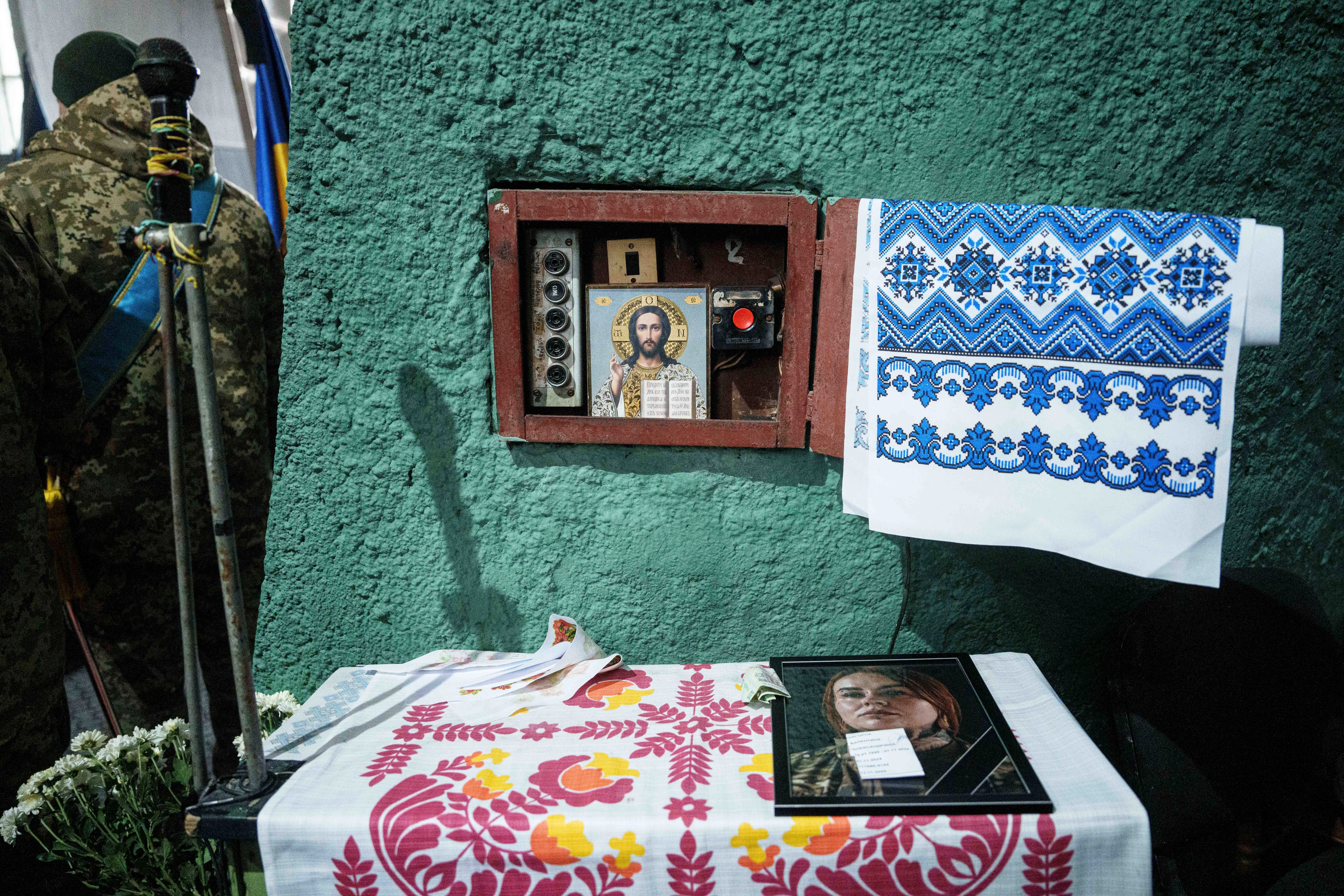 A photo of Valentyna Nagorna known as "Valkiria", a Ukrainian military medic of 3rd assault brigade who was killed together with her boyfriend Danylo Liashkevych known as "Berserk", during the funeral ceremony at a crematorium in Kyiv, Ukraine, Friday Nov. 8, 2024. (AP Photo/Evgeniy Maloletka)