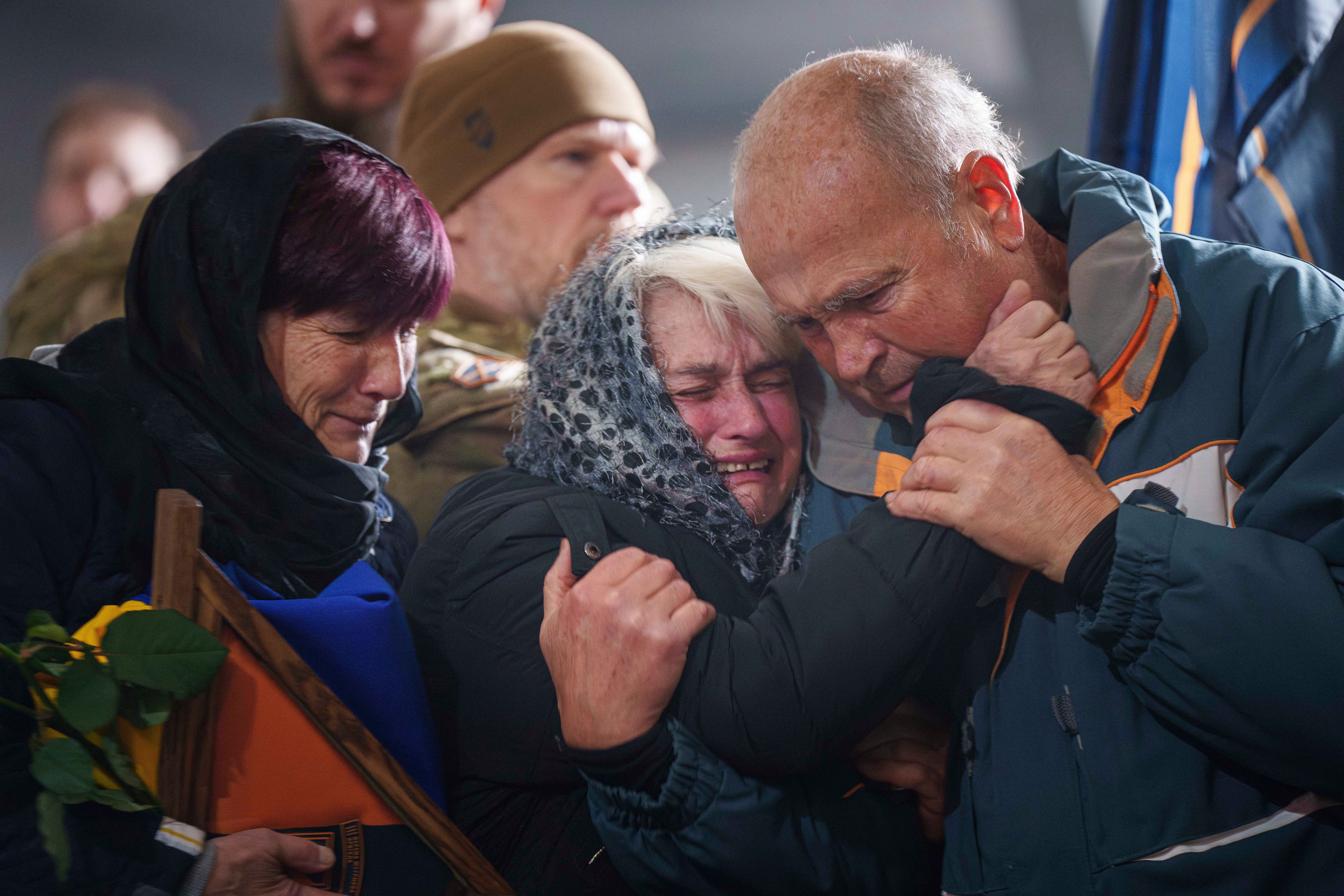 Relatives of Danylo Liashkevych aka "Berserk", Ukrainian serviceman of 3rd assault brigade, cry during the funeral ceremony at crematorium in Kyiv, Ukraine, Nov. 8, 2024. (AP Photo/Evgeniy Maloletka)