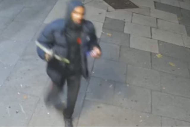 <p>CCTV shows a man in a dark hooded puffer jacket brandishing a crossbow</p>