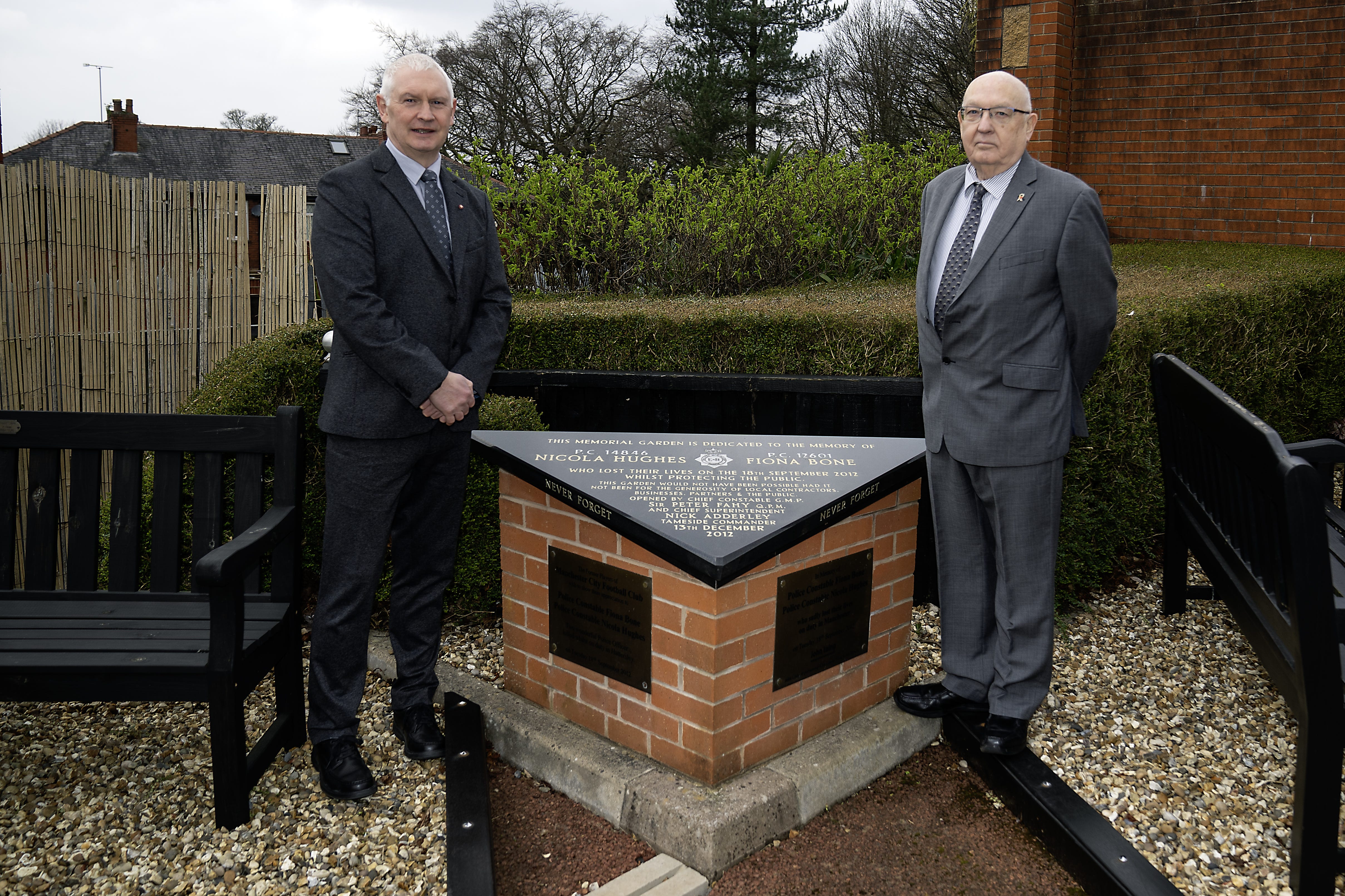 Bryn Hughes and Paul Bone (right), the fathers of murdered Pcs Nicola Hughes and Fiona Bone, at the Hyde police station memorial garden, in Manchester (PA / Peter Byrne).