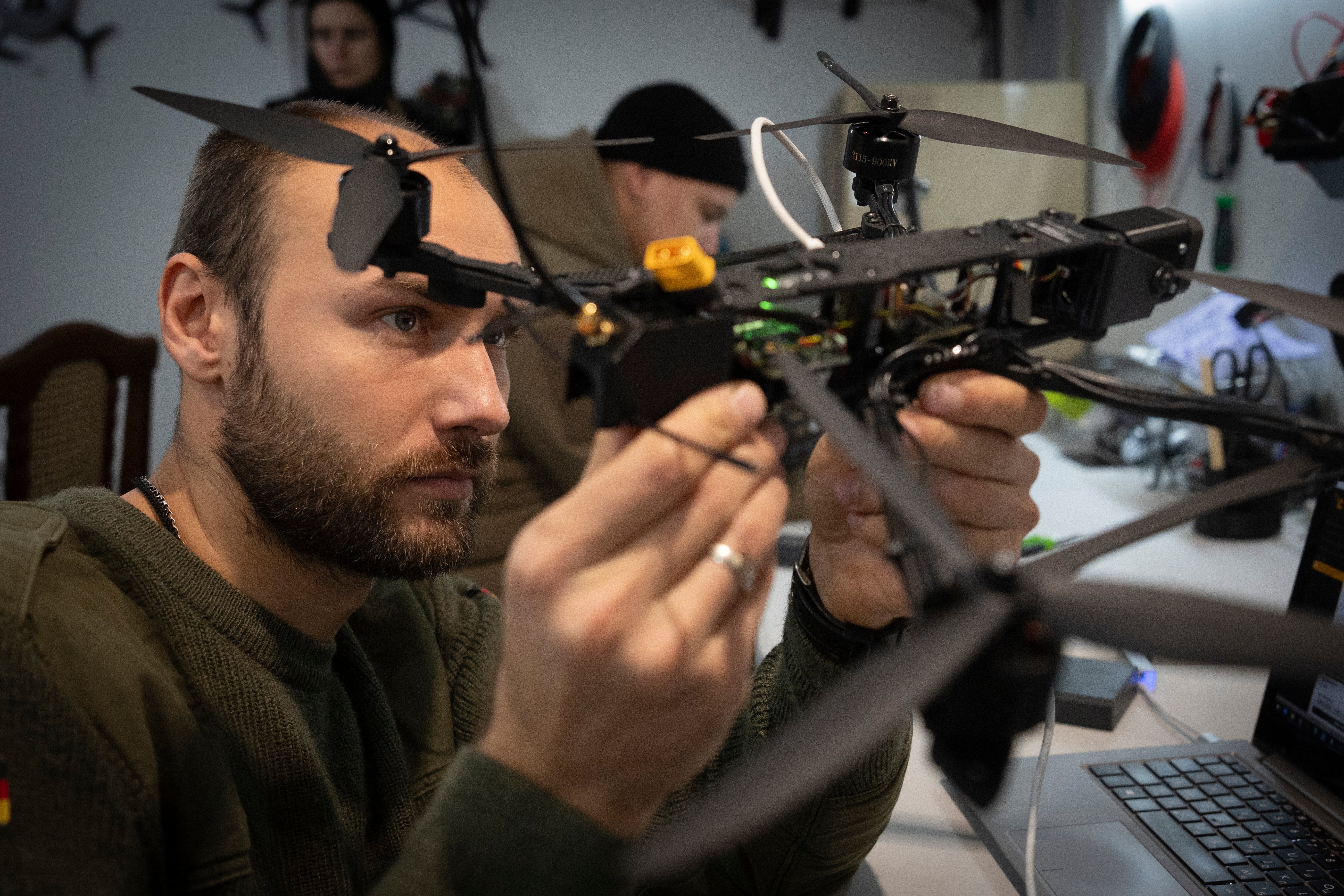 A soldier of Ukraine’s 57th motorised brigade inspects a drone near front line in the Kharkiv region, Ukraine