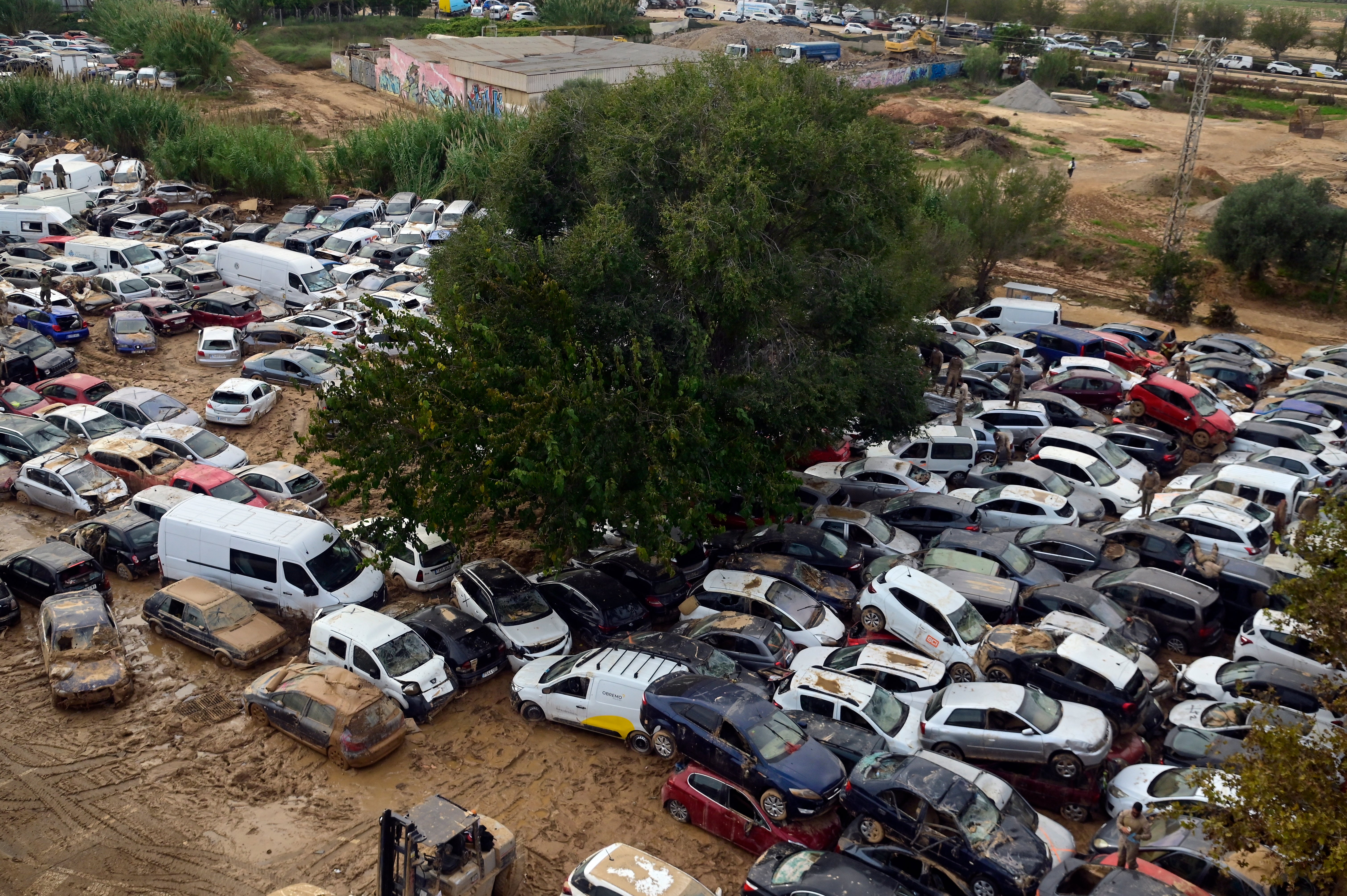 Soldiers search wrecked cars damaged by flooding in Massassana, a region of Valencia, eastern Spain