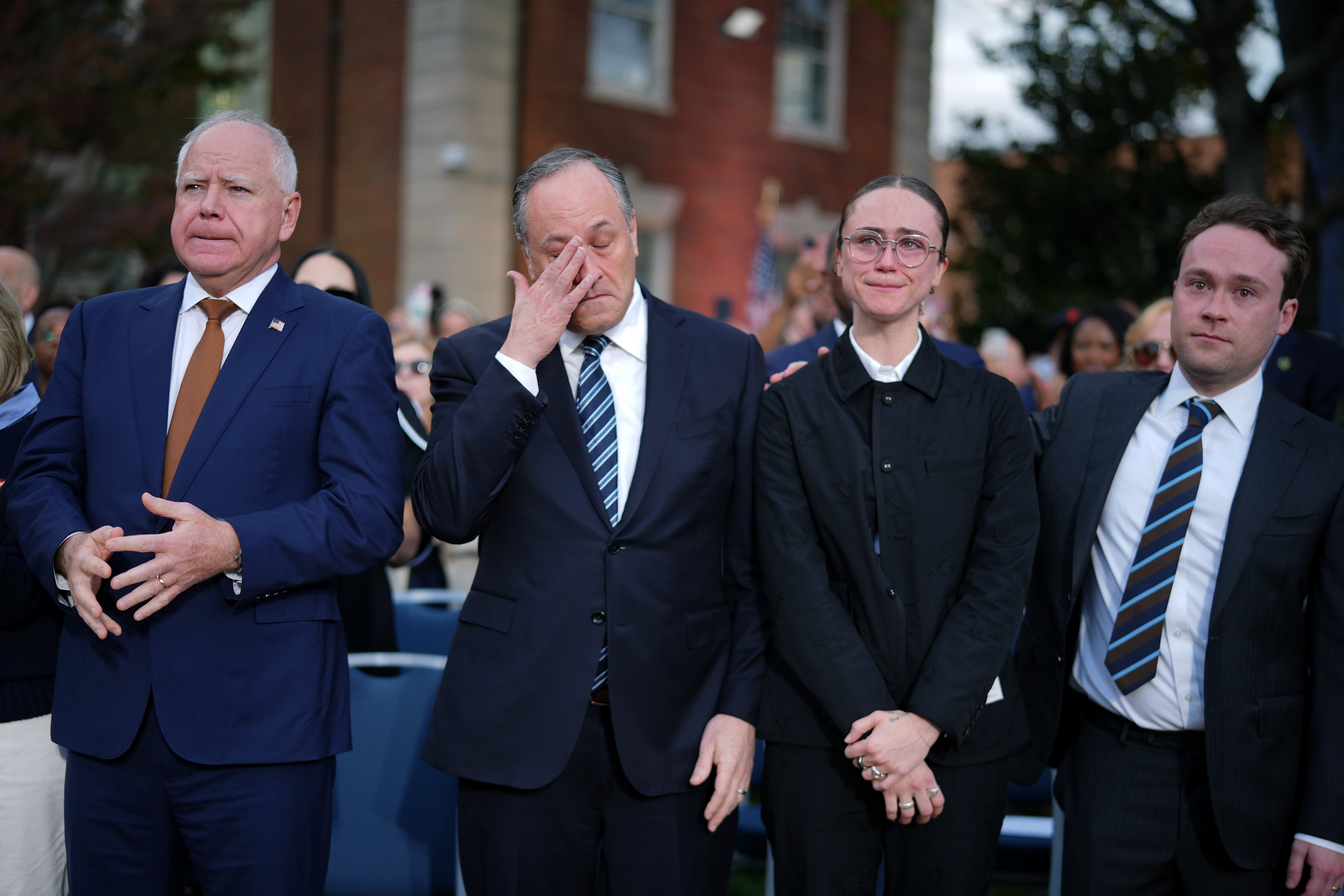 Ella Emhoff with Tim Walz (left), Doug Emhoff (inner left), and Cole Emhoff (right) at Kamala Harris’s concession speech