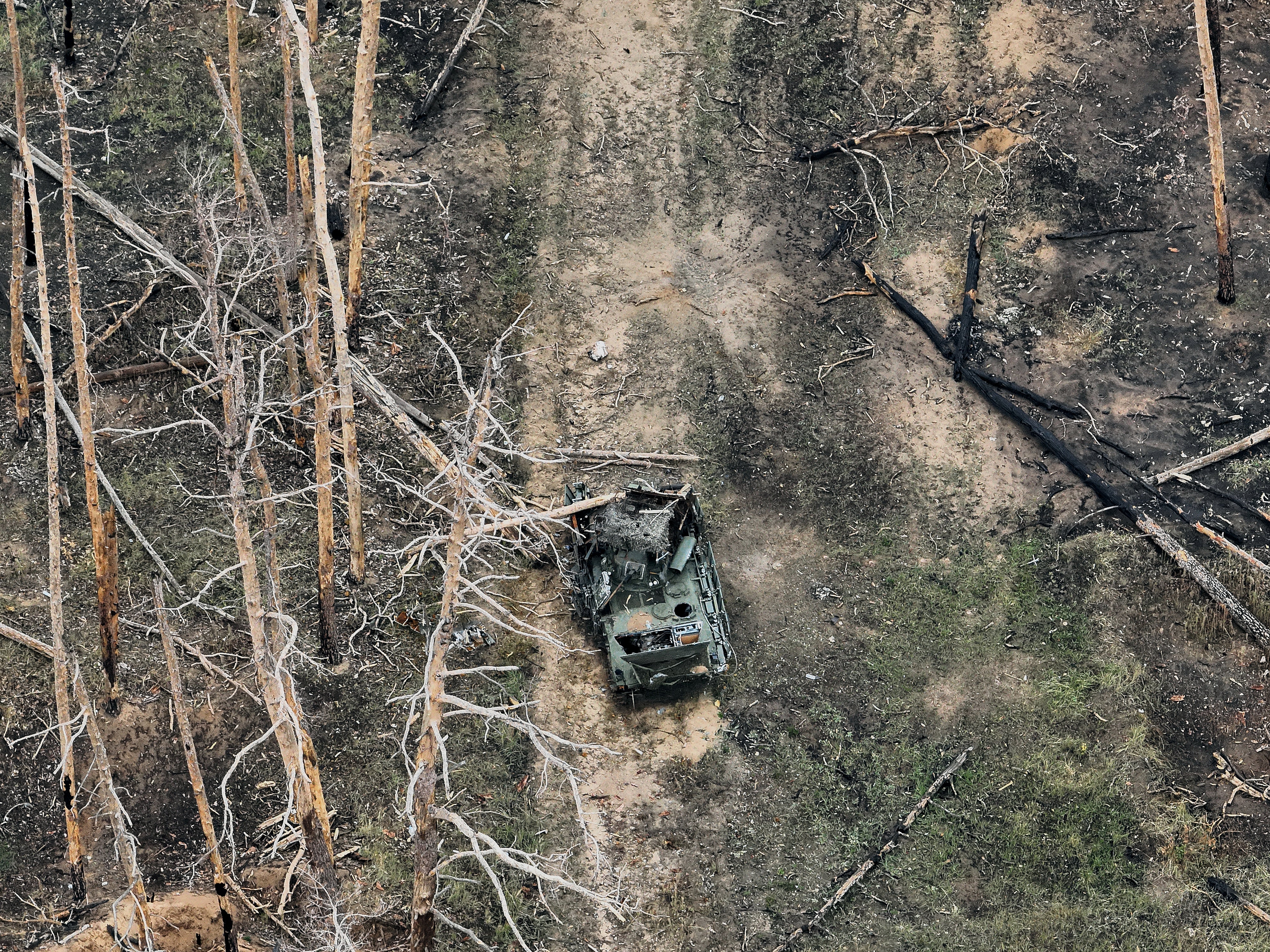 A view from a drone showing a destroyed Russian armoured vehicle near Kreminna