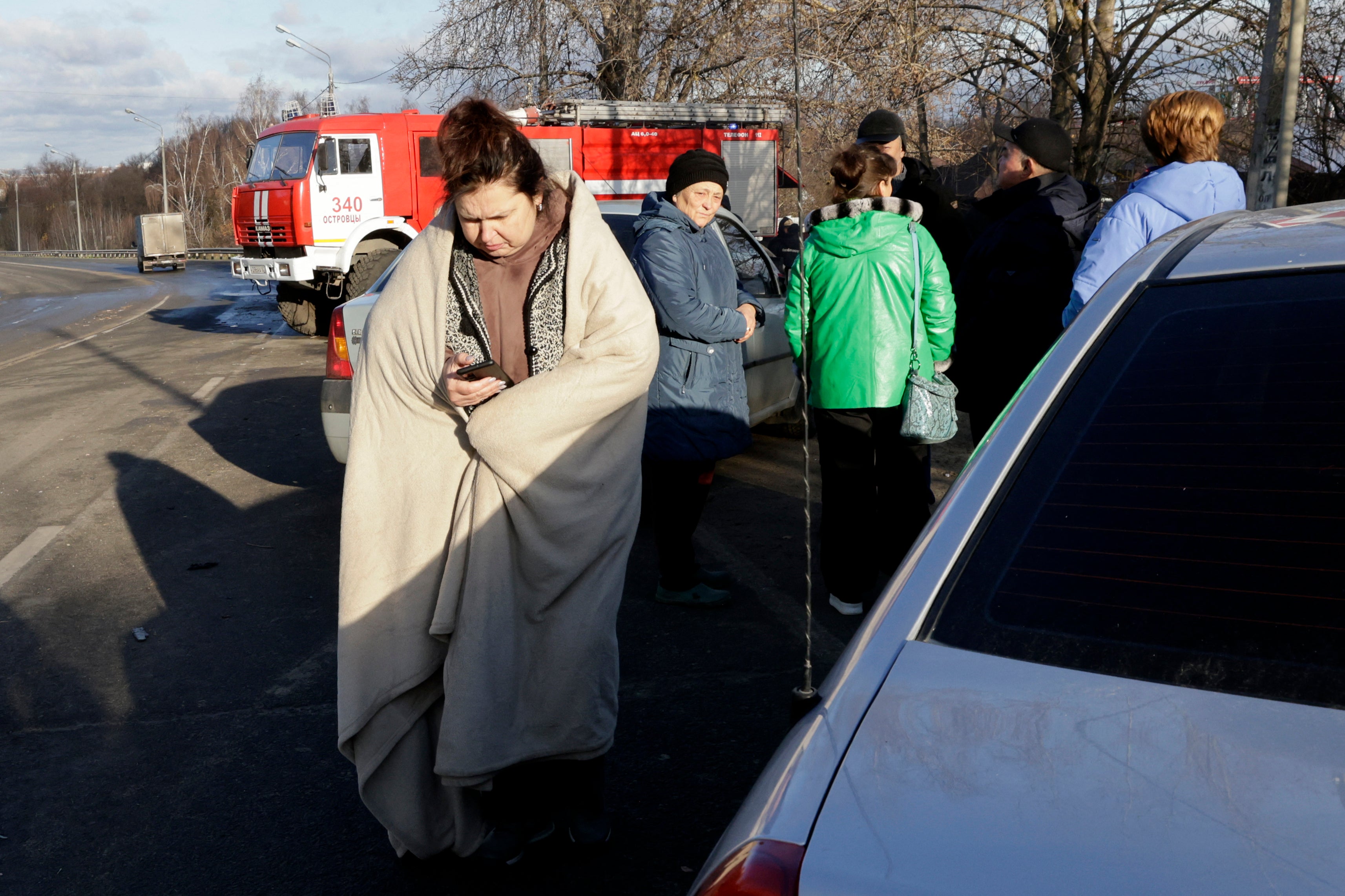 Local residents gather at the site of a drone attack in the village of Stanovoye, Moscow region