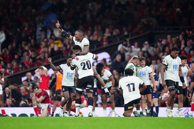 <p>Fiji players celebrate their victory at the Principality Stadium</p>