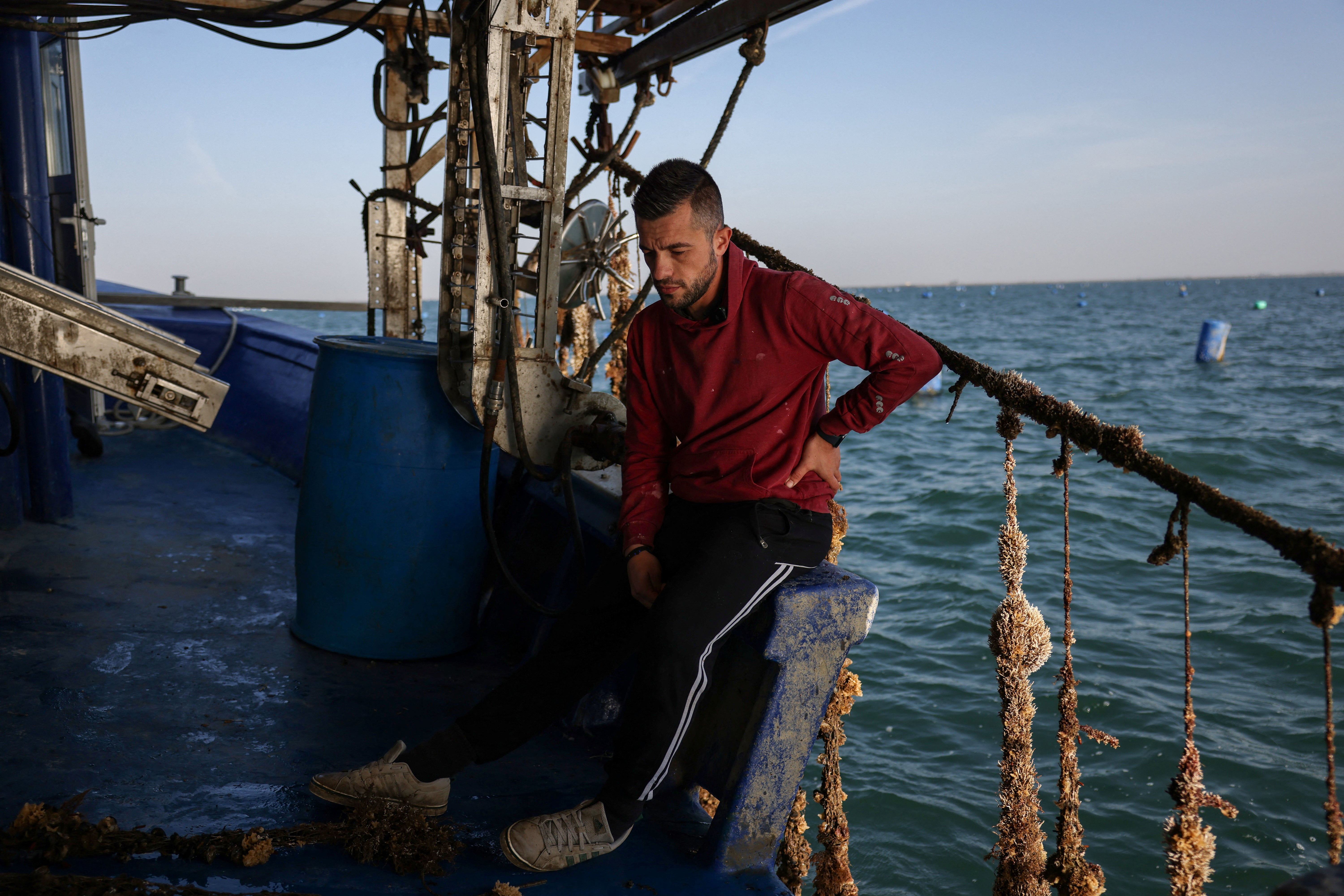 Mussel farmer Anastasios Zakalkas, 35, reacts on a boat at his mussel farm at the Thermaic Gulf, near Thessaloniki, Greece