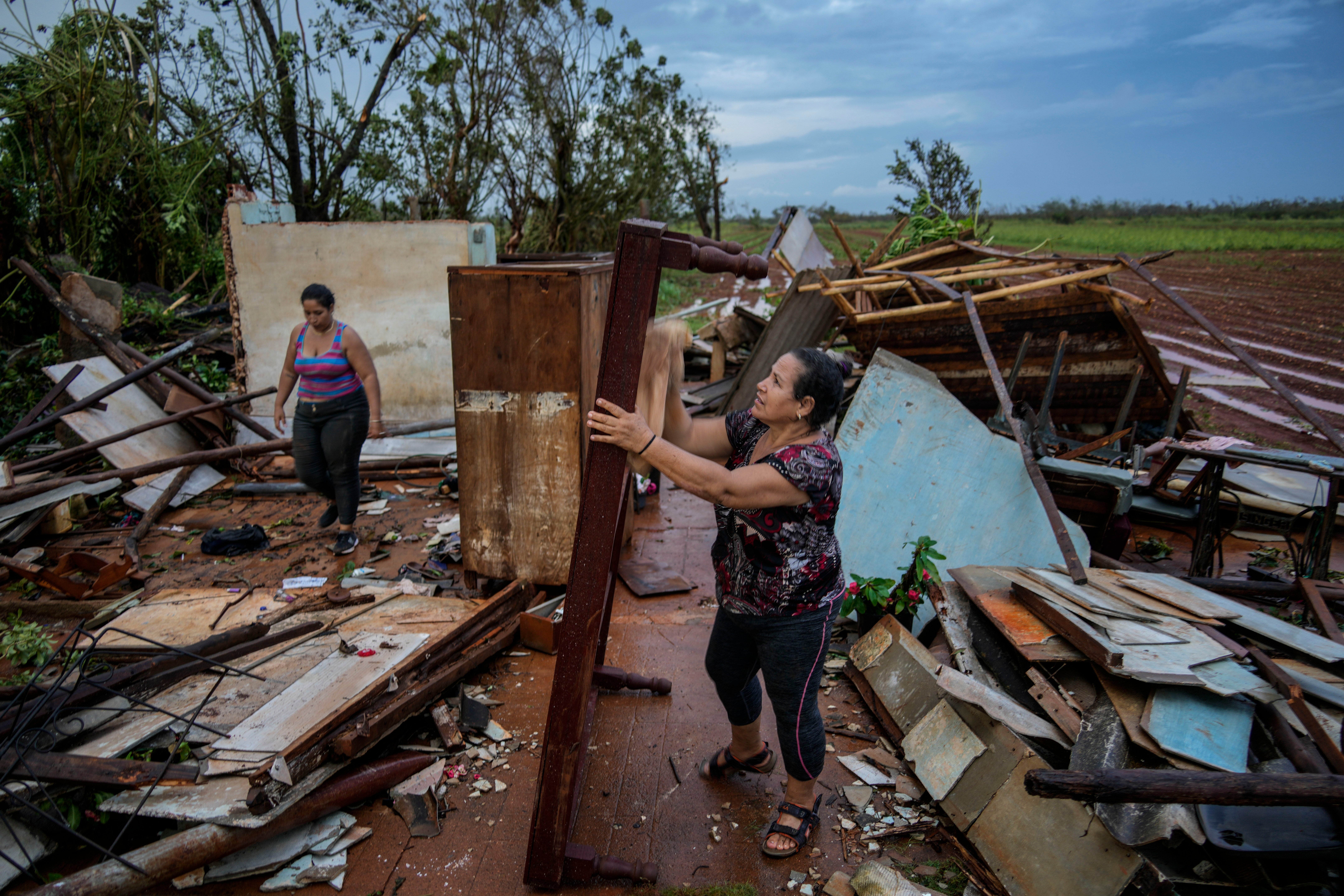 People recover belongings from their houses, which were destroyed by Hurricane Rafael, in Alquizar, Cuba, on Thursday. The hurricane struck western Cuba as a Category 3 storm.