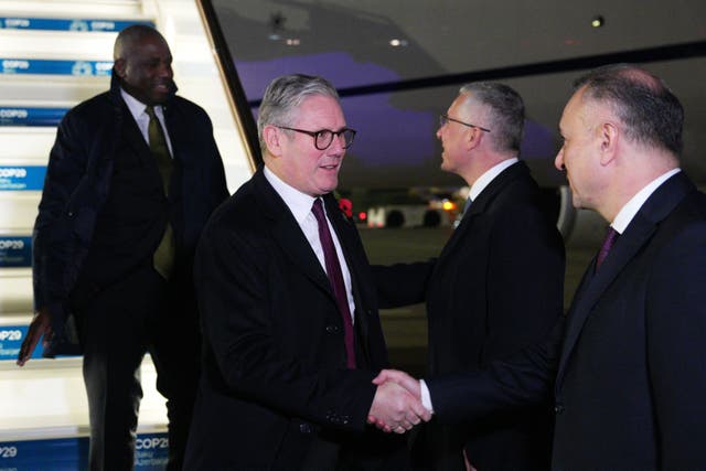Prime Minister Sir Keir Starmer (centre) and Foreign Secretary David Lammy (left) arrive at Heydar Aliyev International Airport in Baku (Carl Court/PA)