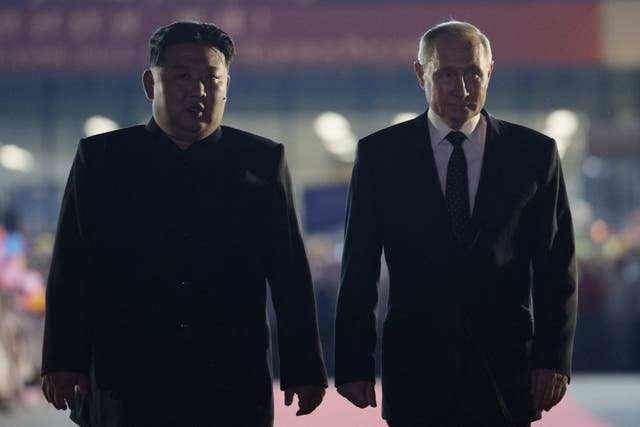 <p>In this pool photograph distributed by the Russian state agency Sputnik, Russian President Vladimir Putin (R) and North Korean leader Kim Jong Un walk during a farewell ceremony upon Putin's departure at the Sunan International Airport in Pyongyang on June 19, 2024. Putin enjoyed a red carpet welcome, a military ceremony and an embrace from North Korea's Kim Jong Un during a state visit to Pyongyang where they both pledged to forge closer ties. (Photo by Vladimir Smirnov / POOL / AFP) / -- Editor's note : this image is distributed by the Russian state owned agency Sputnik </p>