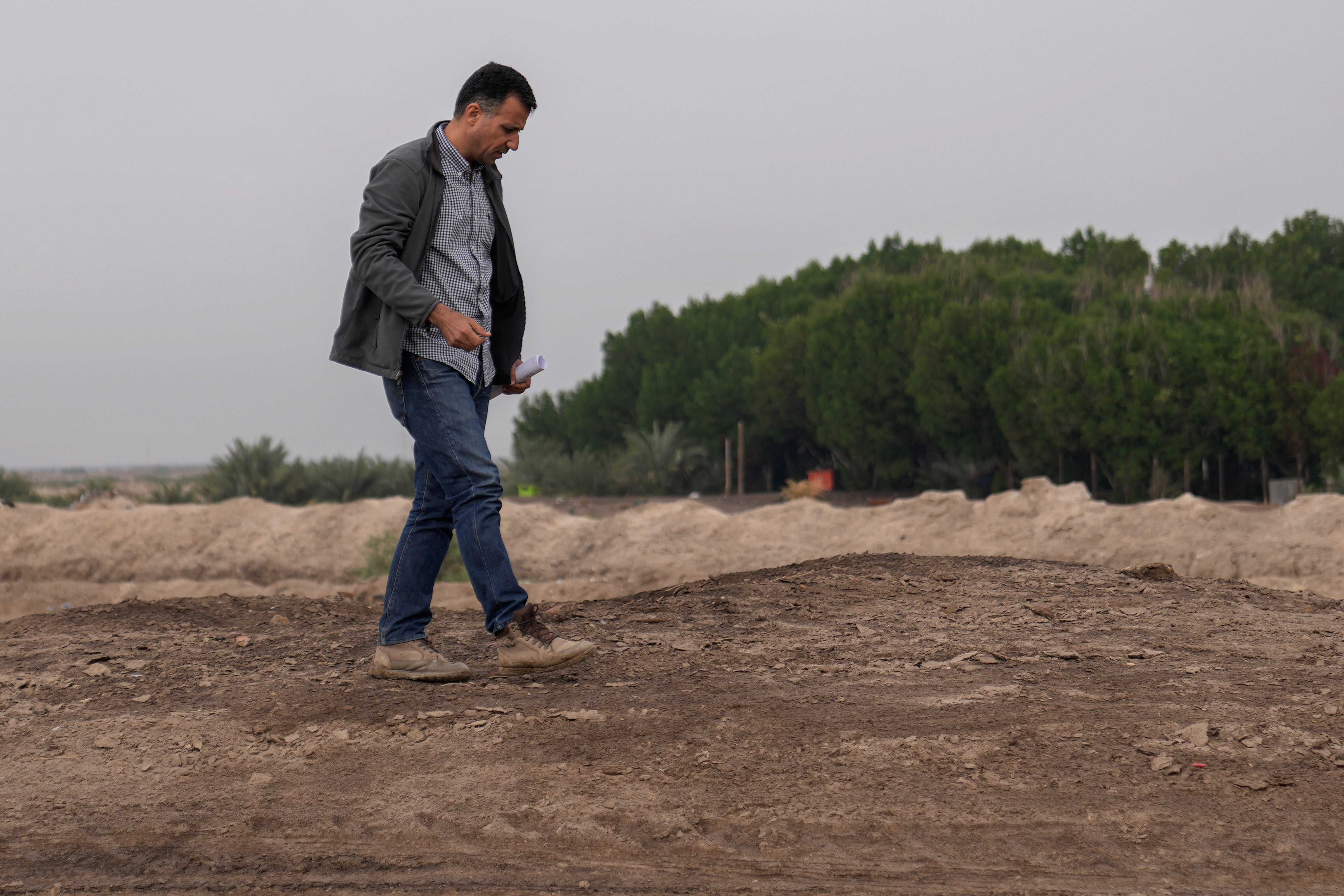 Dr Jaafar al Jotheri holds satellite images and explores the site of the Battle of al-Qadisiyah