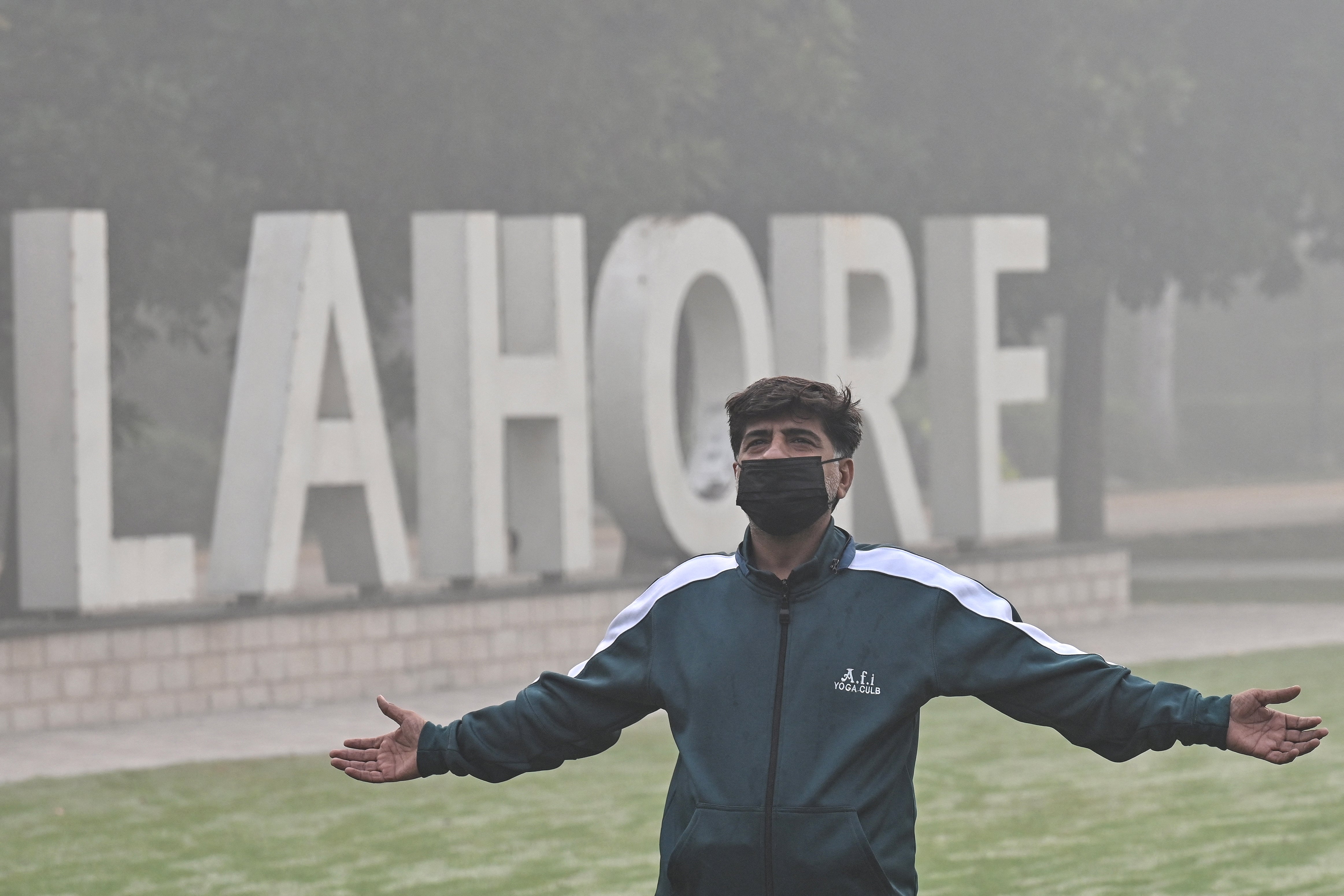 A man exercises in a park amid heavy smog in Lahore