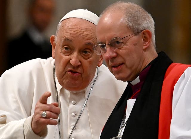 <p>Pope Francis (L) speaks with the archibishop of Canterbury Justin Welby (R) during the celebration of vespers, on the solemnity of the conversion of Saint Paul, in the Basilica of St. Paul Outside The Walls in Rome on January 25, 2024</p>