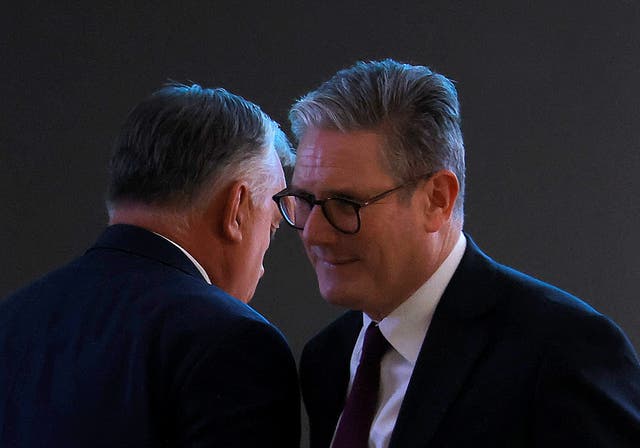 <p>Keir Starmer passes the Hungarian prime minister, Viktor Orban while leaving the stage during Cop29, in Baku, Azerbaijan, on 12 November 2024</p>