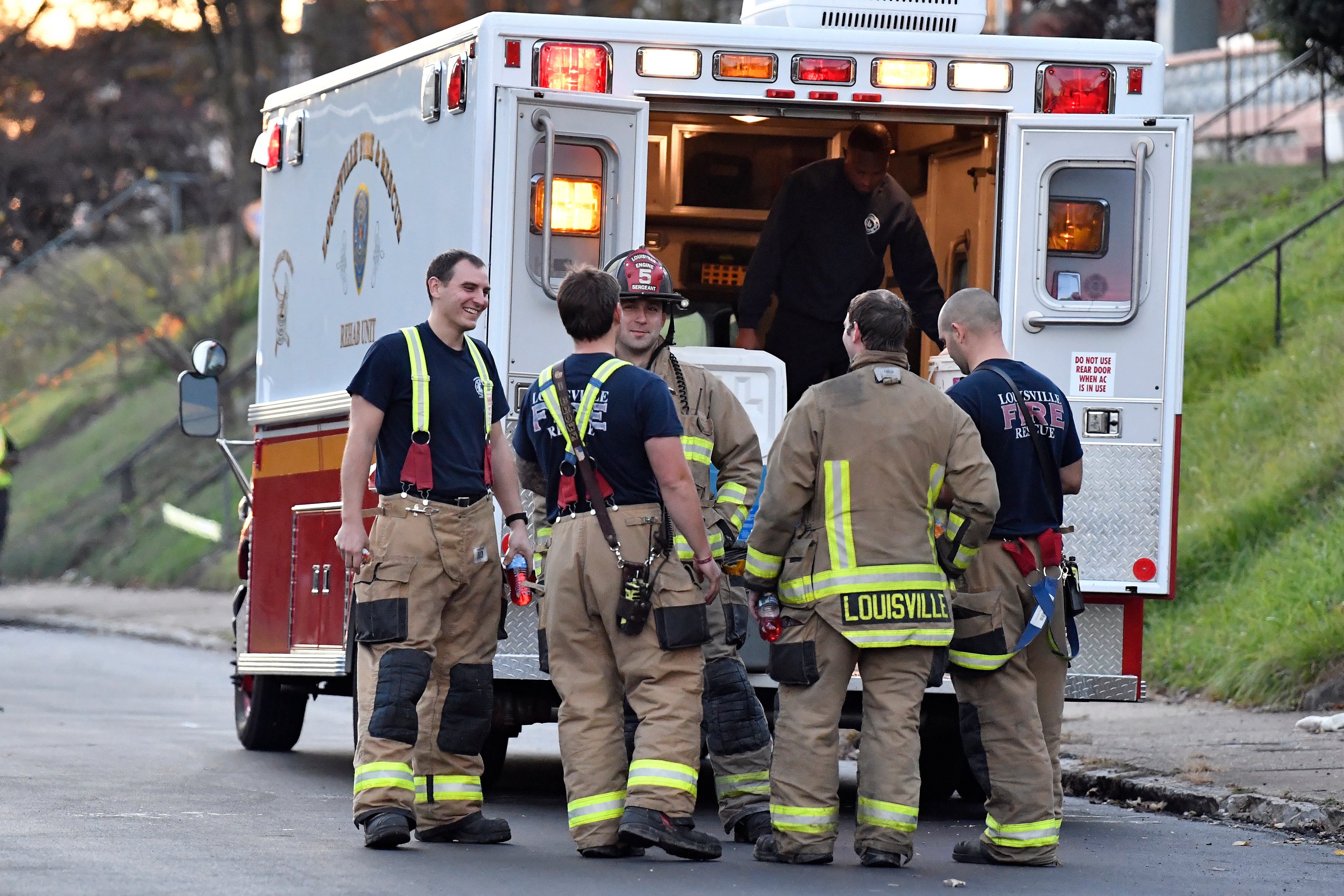 Firefighters check their gear near the site of the Louisville explosion. Two of the injured employees are in critical condition as of Tuesday night