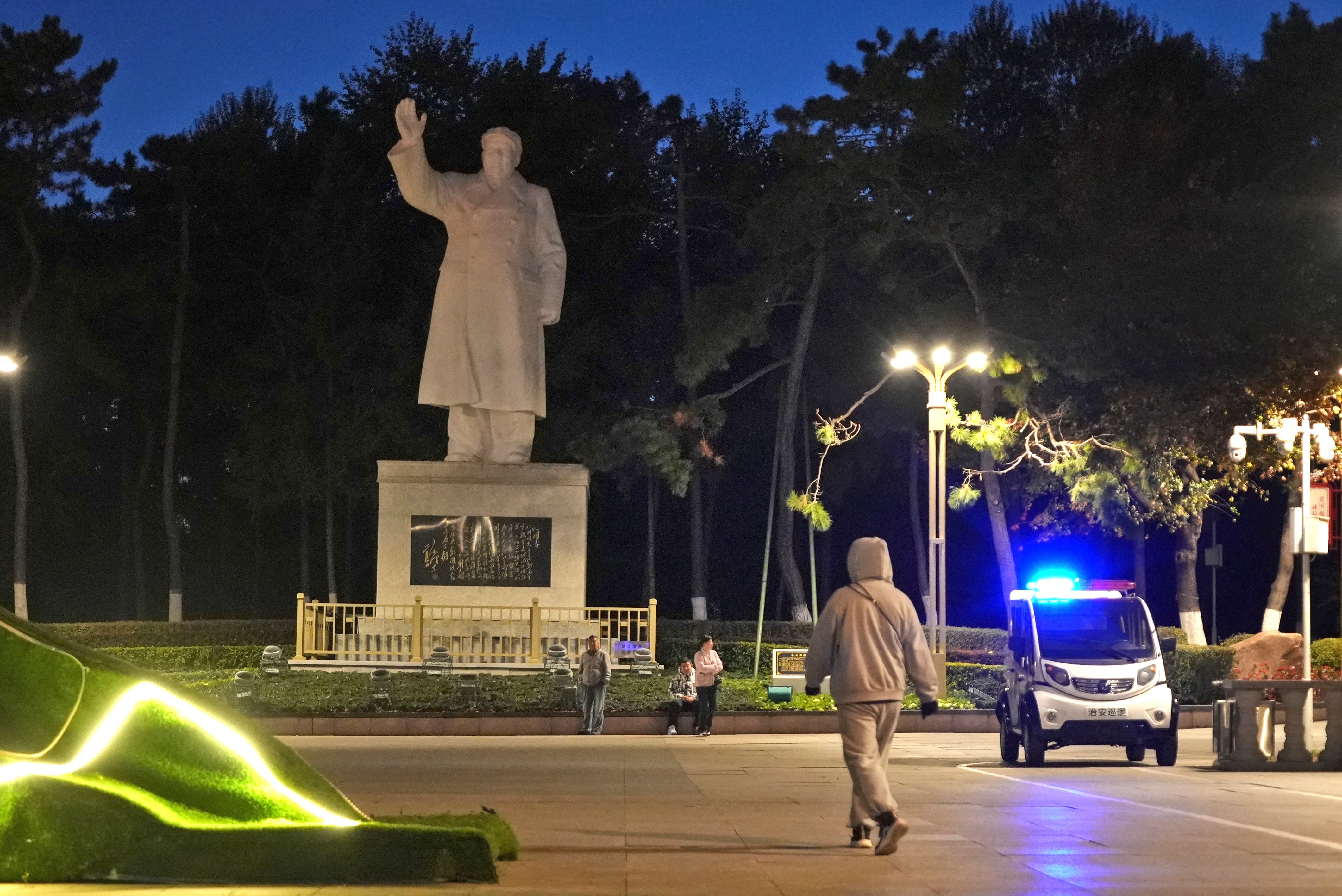 Pedestrian walks by a statue of Chairman Mao Zedong in Changchun, a city located in northwestern China