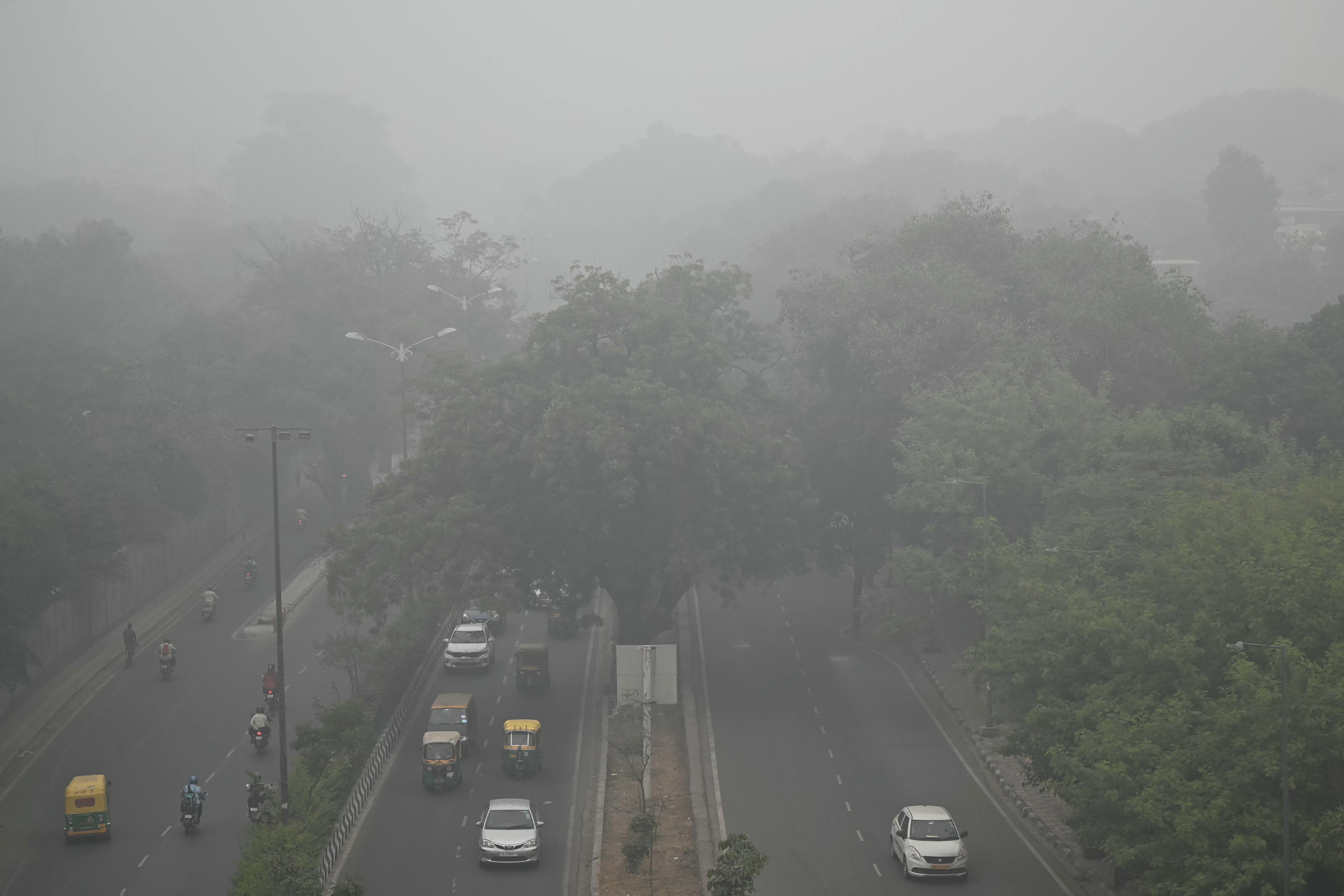 Para komuter berlarian di New Delhi karena kabut tebal