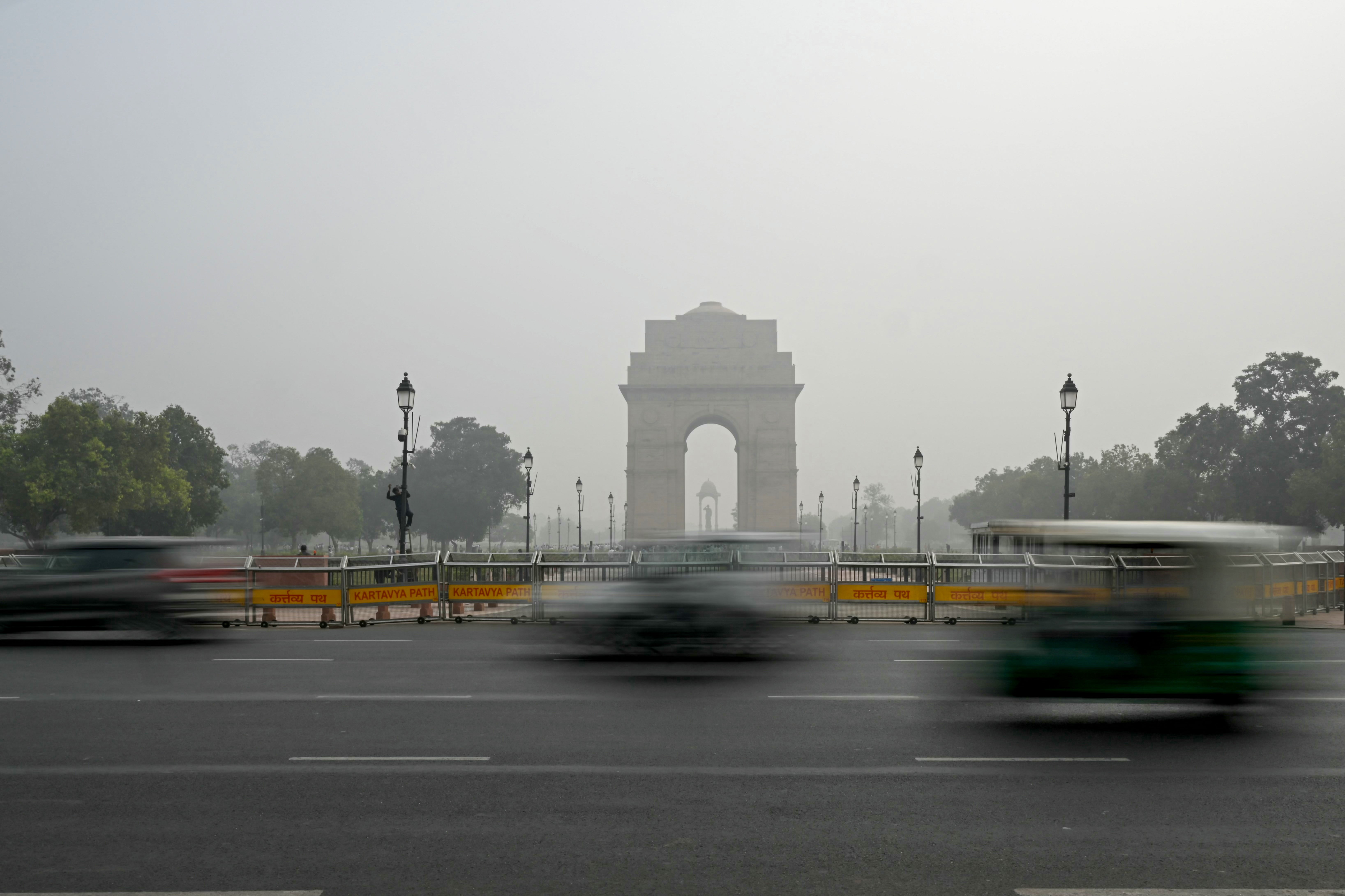 <p>Commuters drive past India Gate engulfed in smog in New Delhi </p>