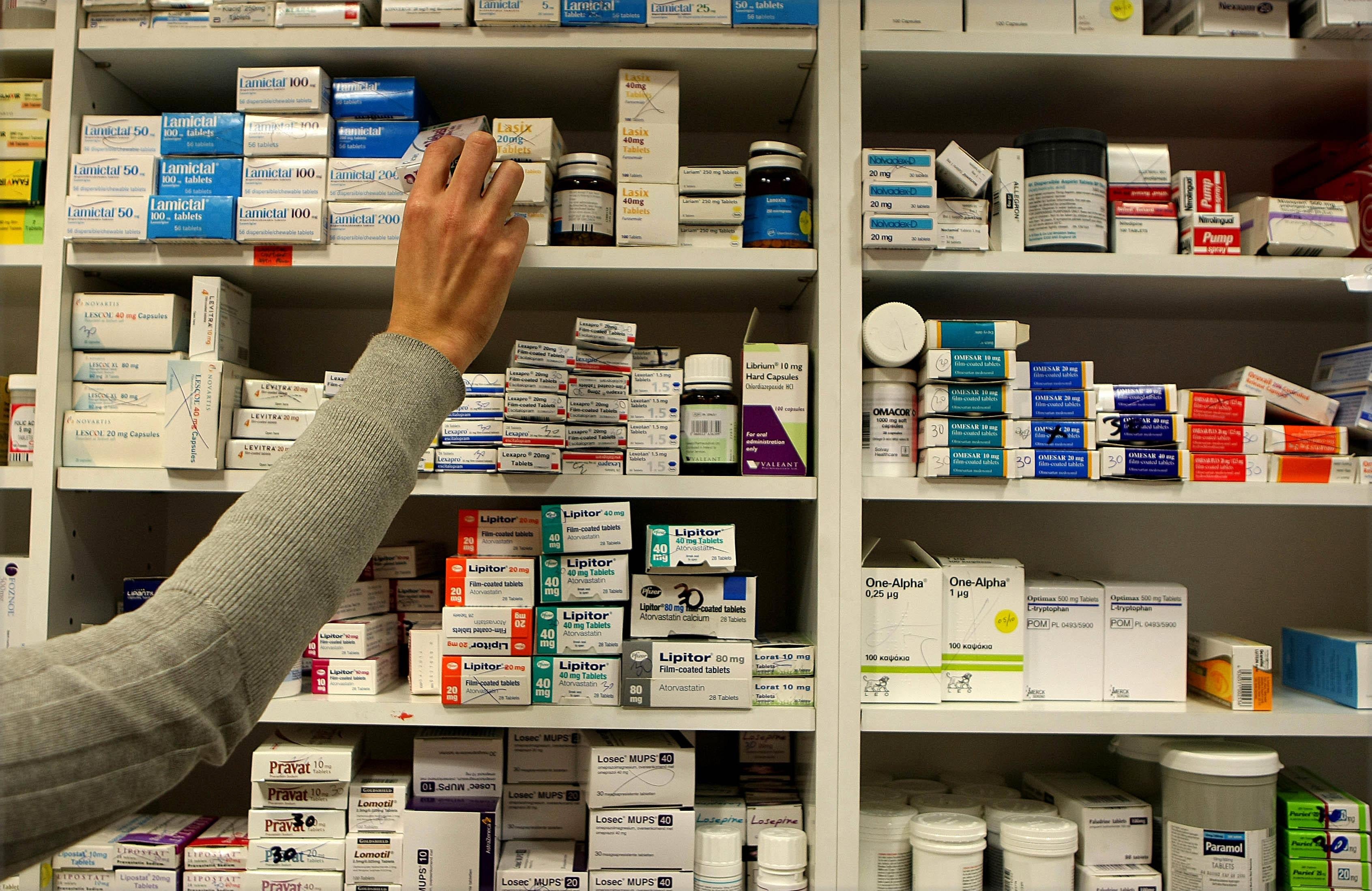 A pharmacist stocking shelves at a chemist