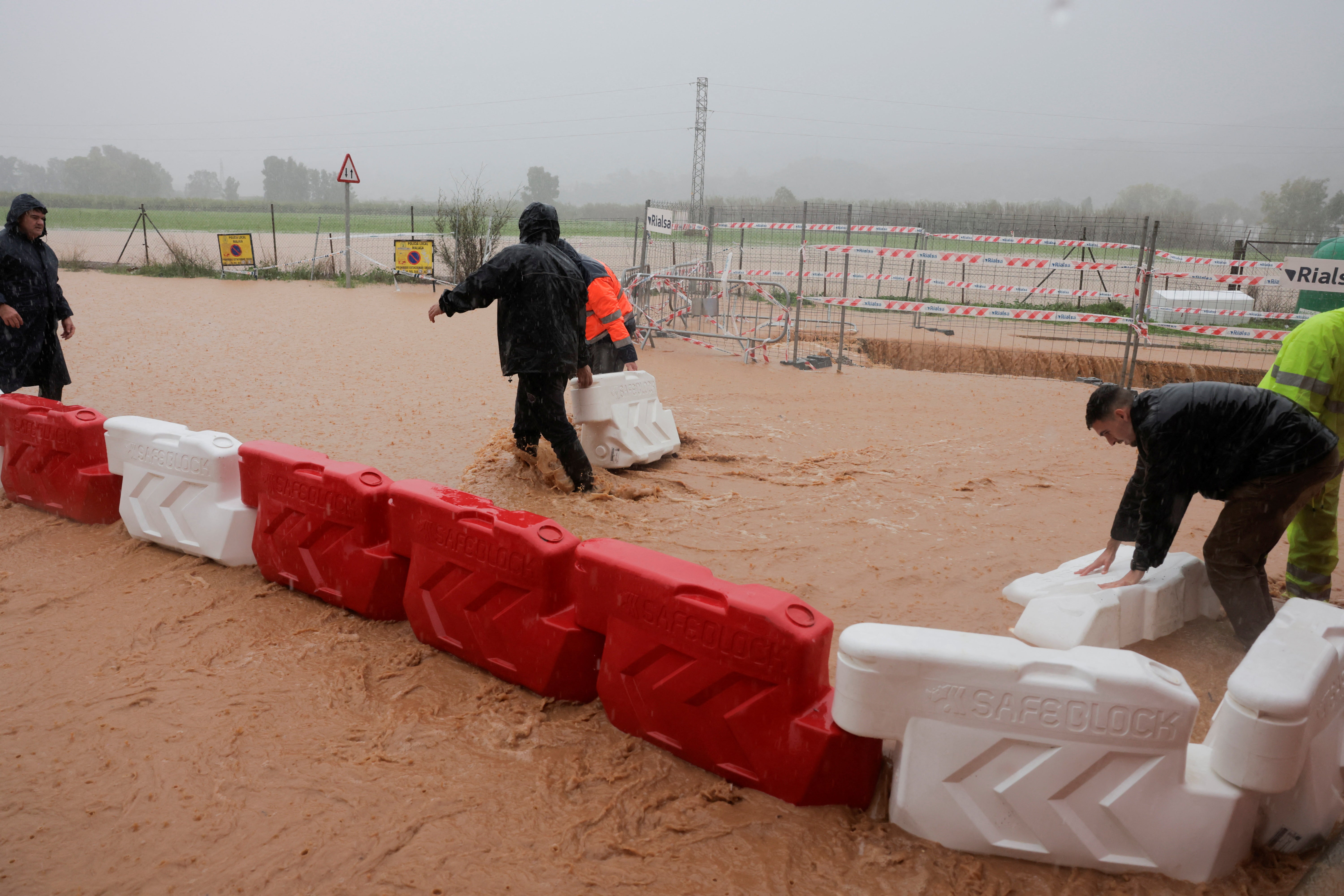 People set up a barricade near the Campanillas river