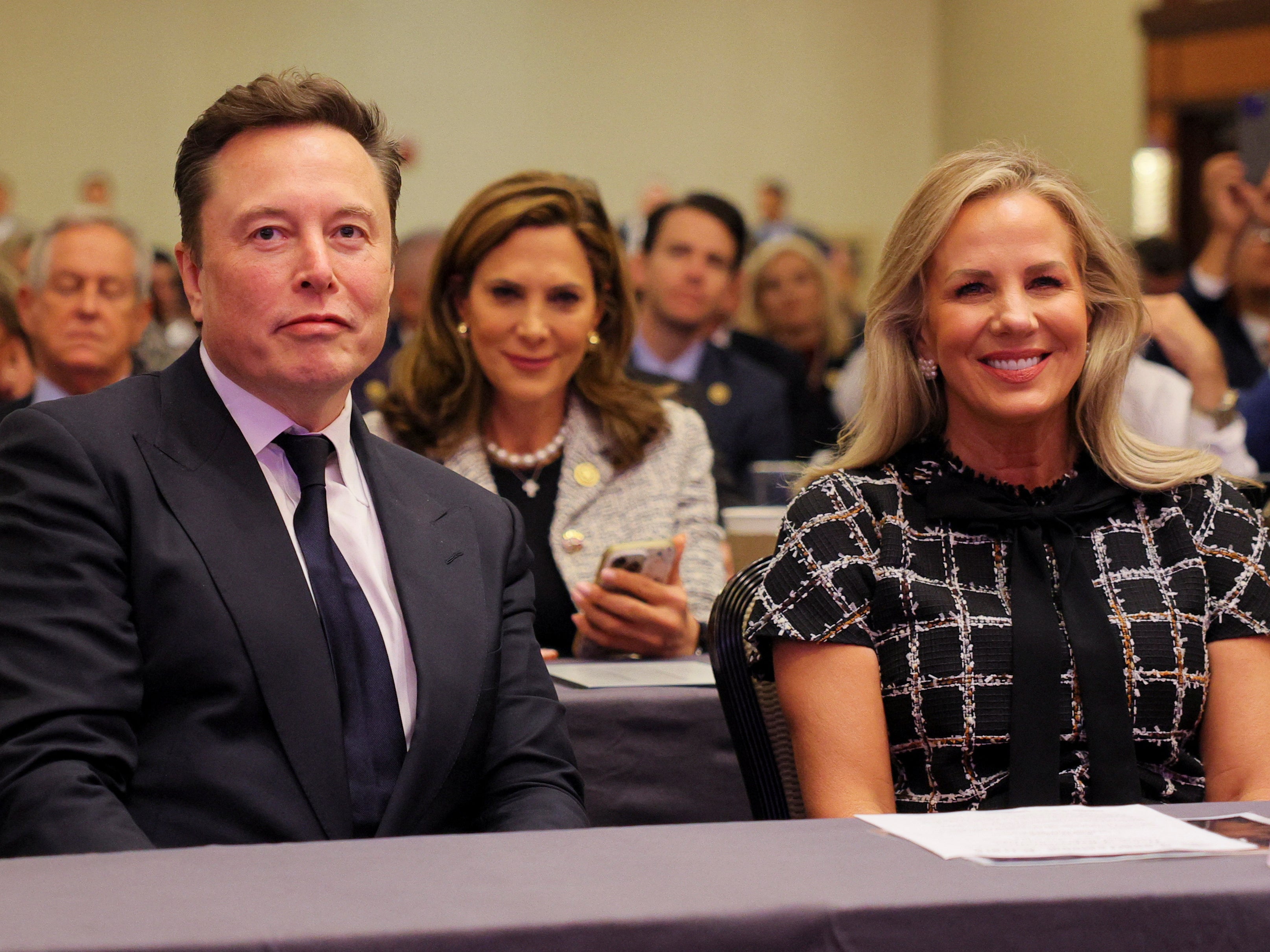 Tesla CEO and X owner Elon Musk sits watching Trump’s address