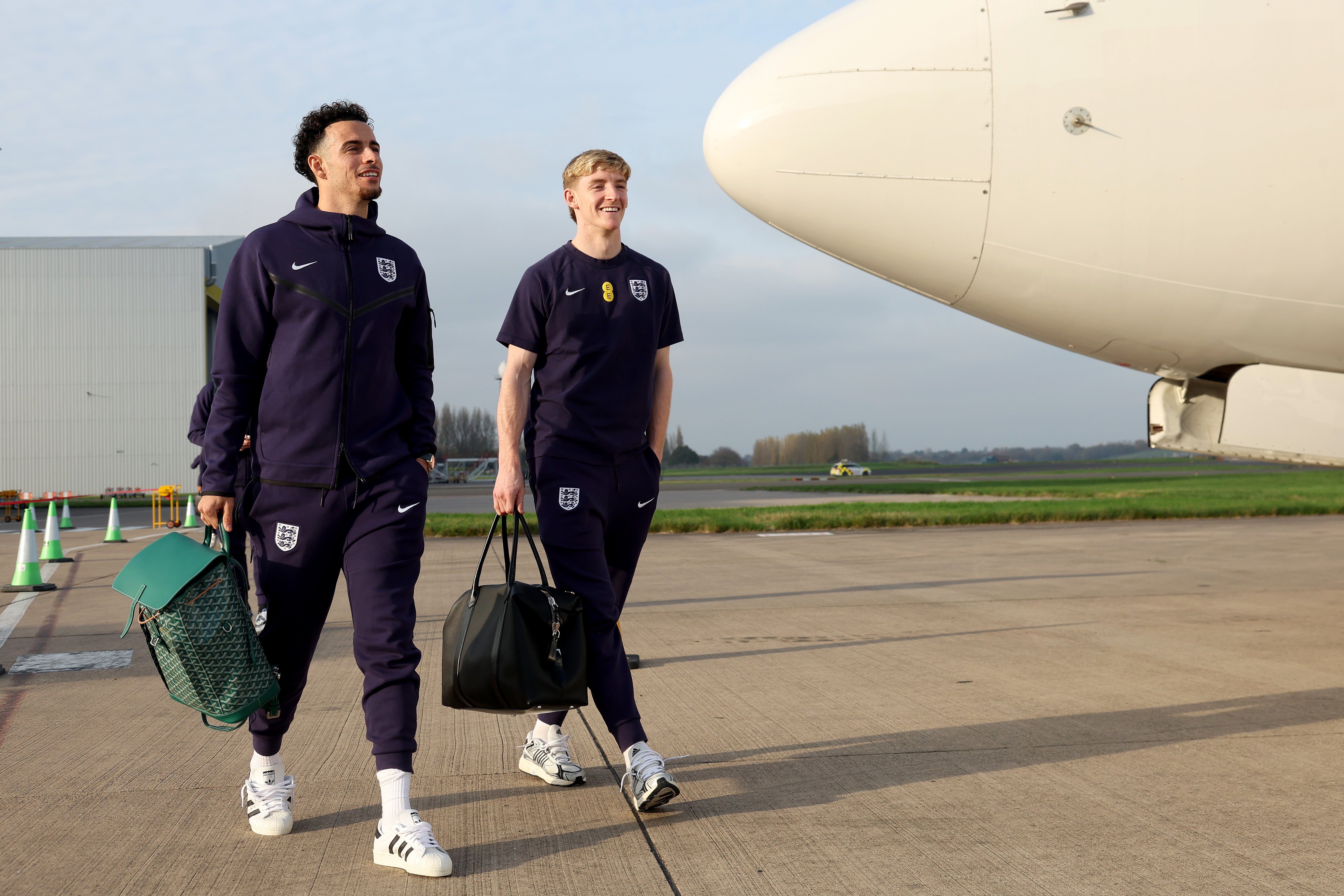 Curtis Jones and Anthony Gordon of England board a plane to Athens