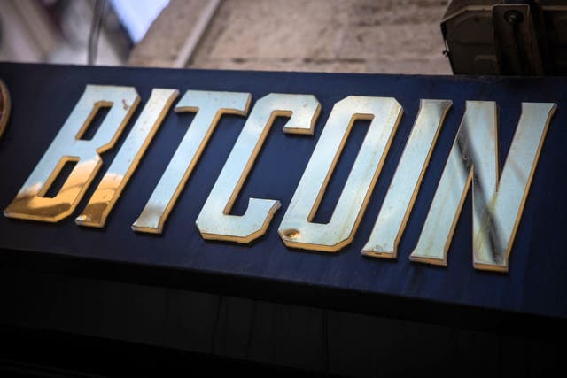 <p>A gold bitcoin sign is seen at the entrance of a cryptocurrency exchange on 8 November, 2024 in Istanbul, Turkey</p>