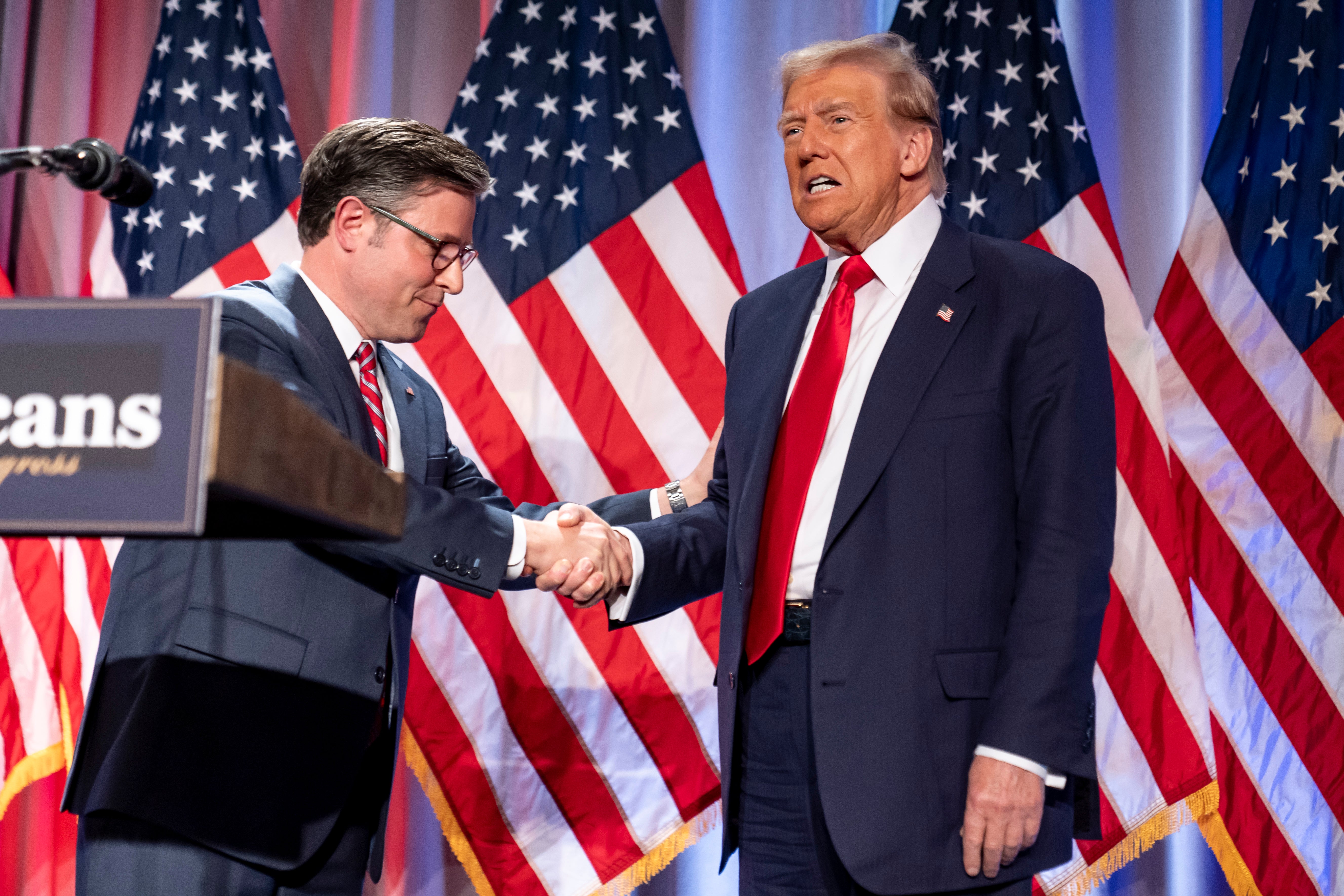 Speaker Mike Johnson shakes Donald Trump’s hand on Wednesday at a meeting of House Republicans