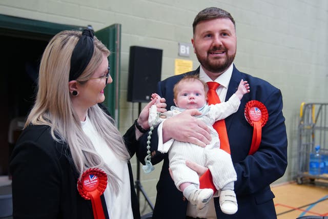 Labour’s Chris Webb celebrated his election win earlier this year with his wife and baby son (Peter Byrne/PA)