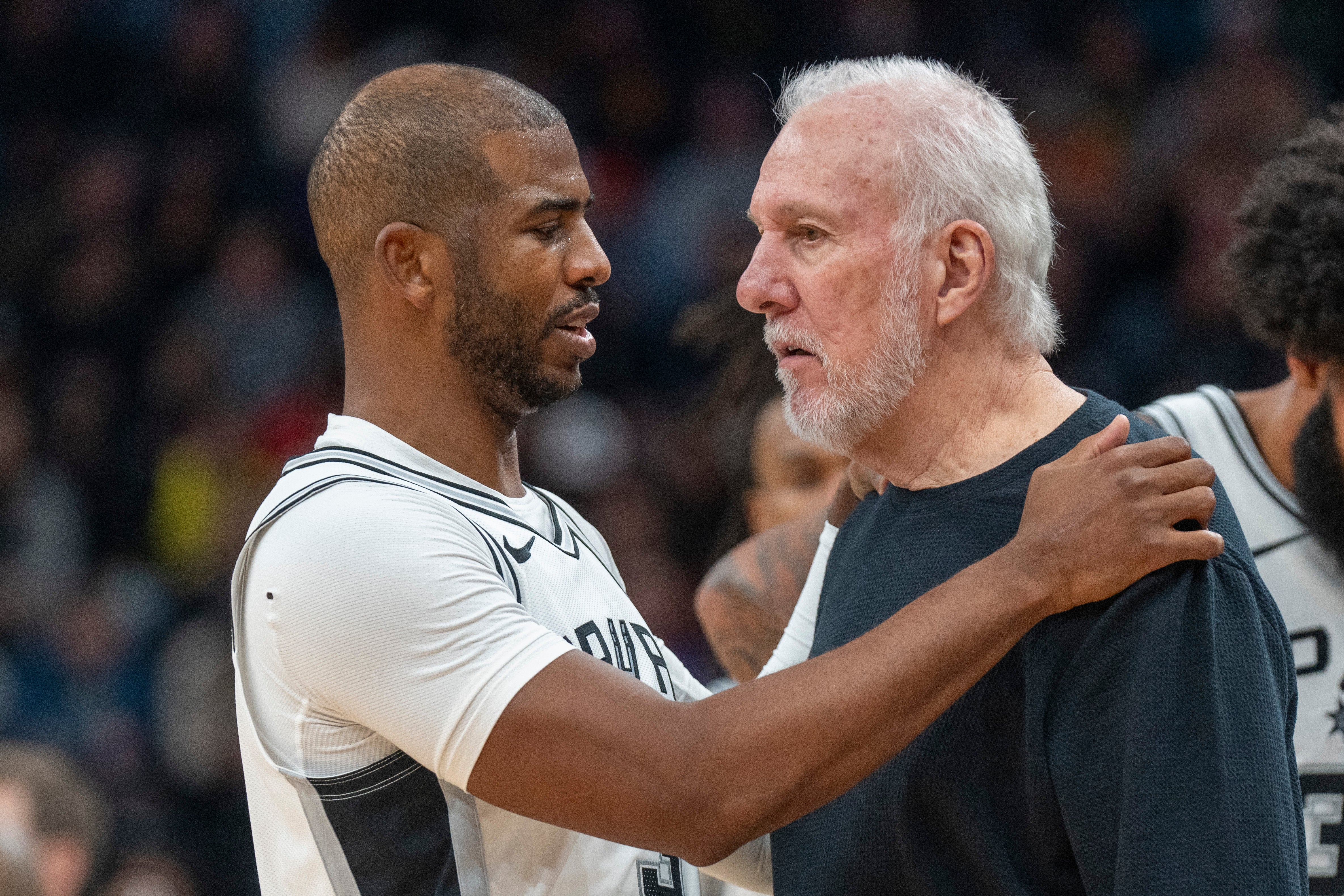 San Antonio Spurs guard Chris Paul has a word with Spurs head coach Gregg Popovich during a game