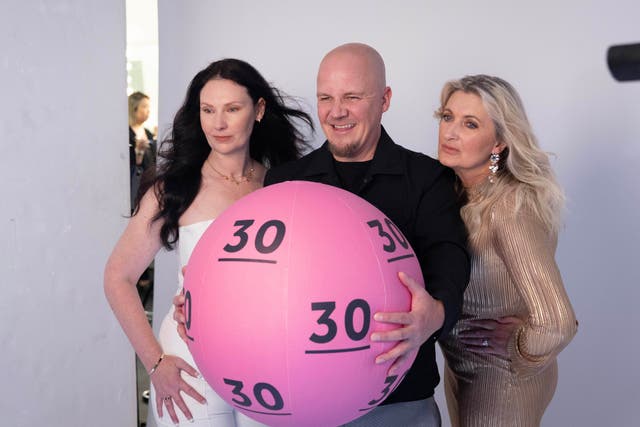 Rankin takes a picture of National Lottery winners (left to right) Ceri Roscoe Roberts, Matthew Evans and Geraldine Bradley to celebrate The National Lottery’s 30th birthday (Matt Alexander/PA)