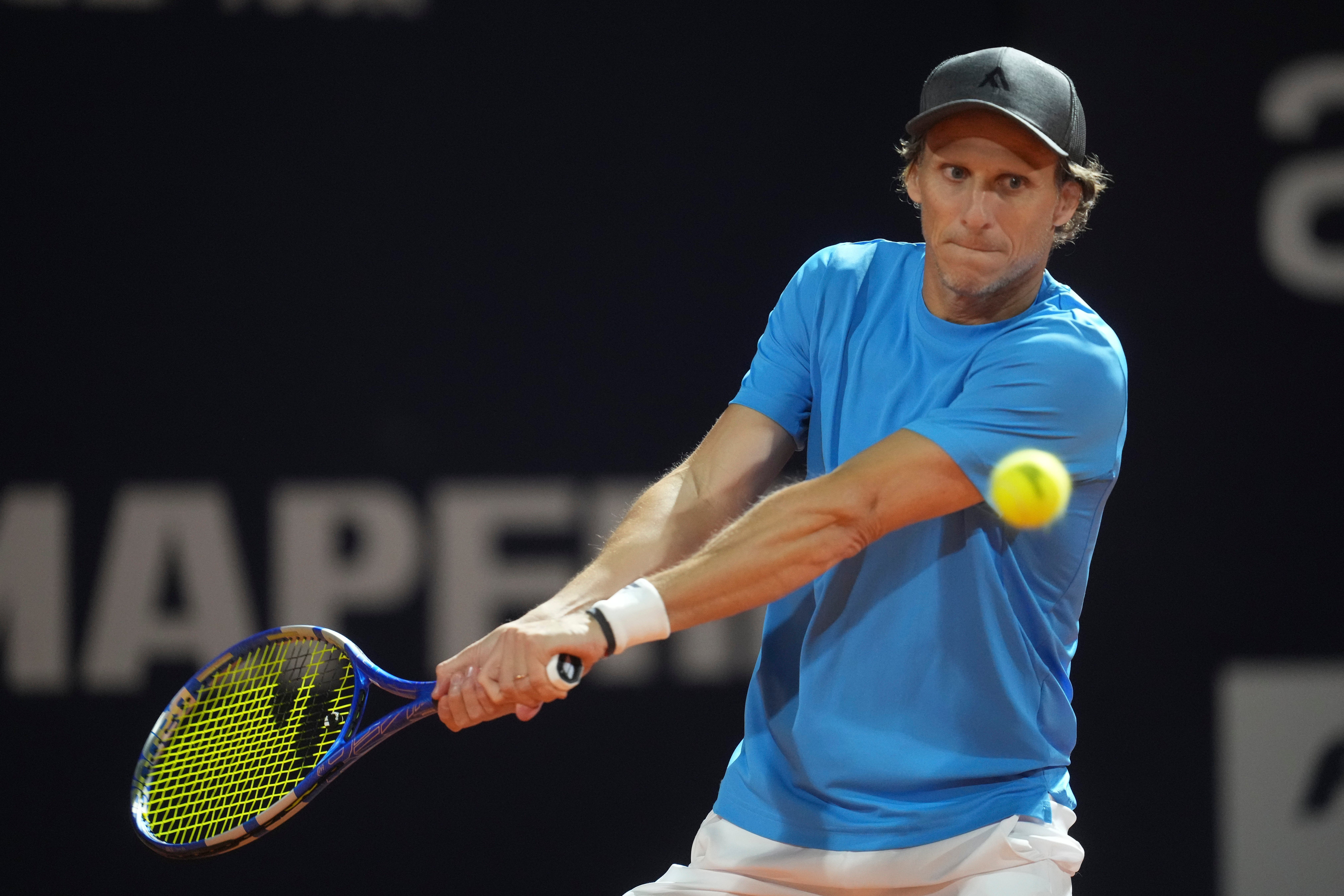 Uruguay’s Diego Forlan returns the ball to Boris Arias and Federico Zeballos during a men’s doubles tennis match at the 2024 Uruguay Open in Montevideo, Uruguay (Matilde Campodonico/AP)