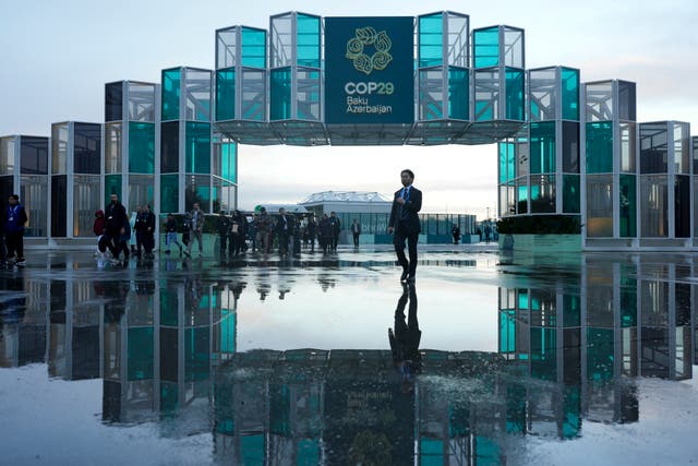 <p>Attendees arrive for the day at Cop29</p>