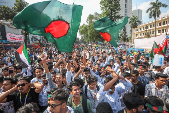 <p>Activists of the anti-discrimination student movement hold national flags and protest against the Awami League party in Bangladesh</p>