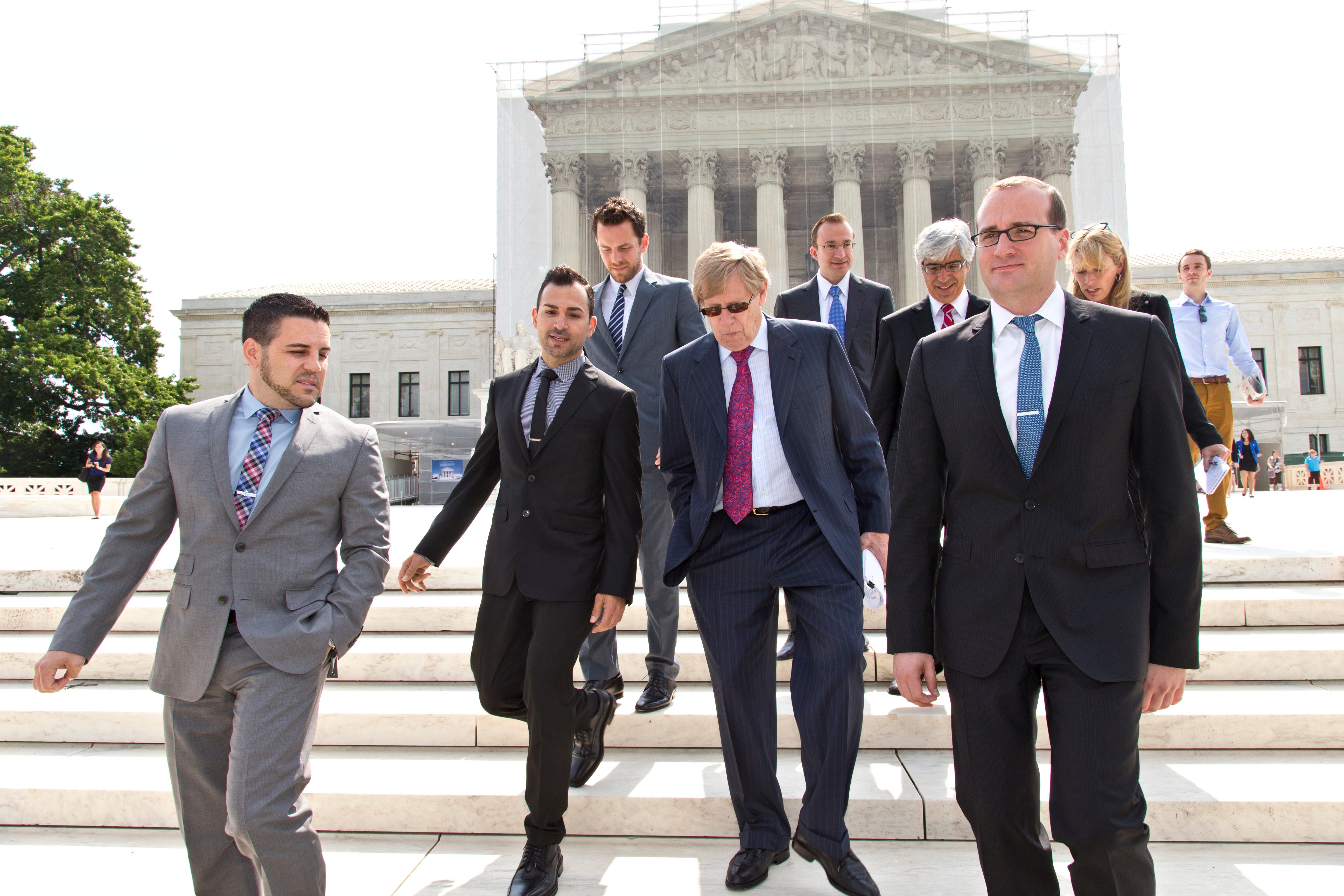 Chad Griffin, right, president of the Human Rights Campaign, leaves the Supreme Court, with Jeff Zarrillo, left, and Paul Katami, second from left, the plaintiffs in the California Proposition 8 case, and their attorney Ted Olson, center, in Washington, June 20, 2013.