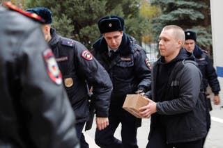 Nikita Zhuravel is escorted by the police to a court prior to a hearing of a treason case in Volgograd, Russia, on Thursday