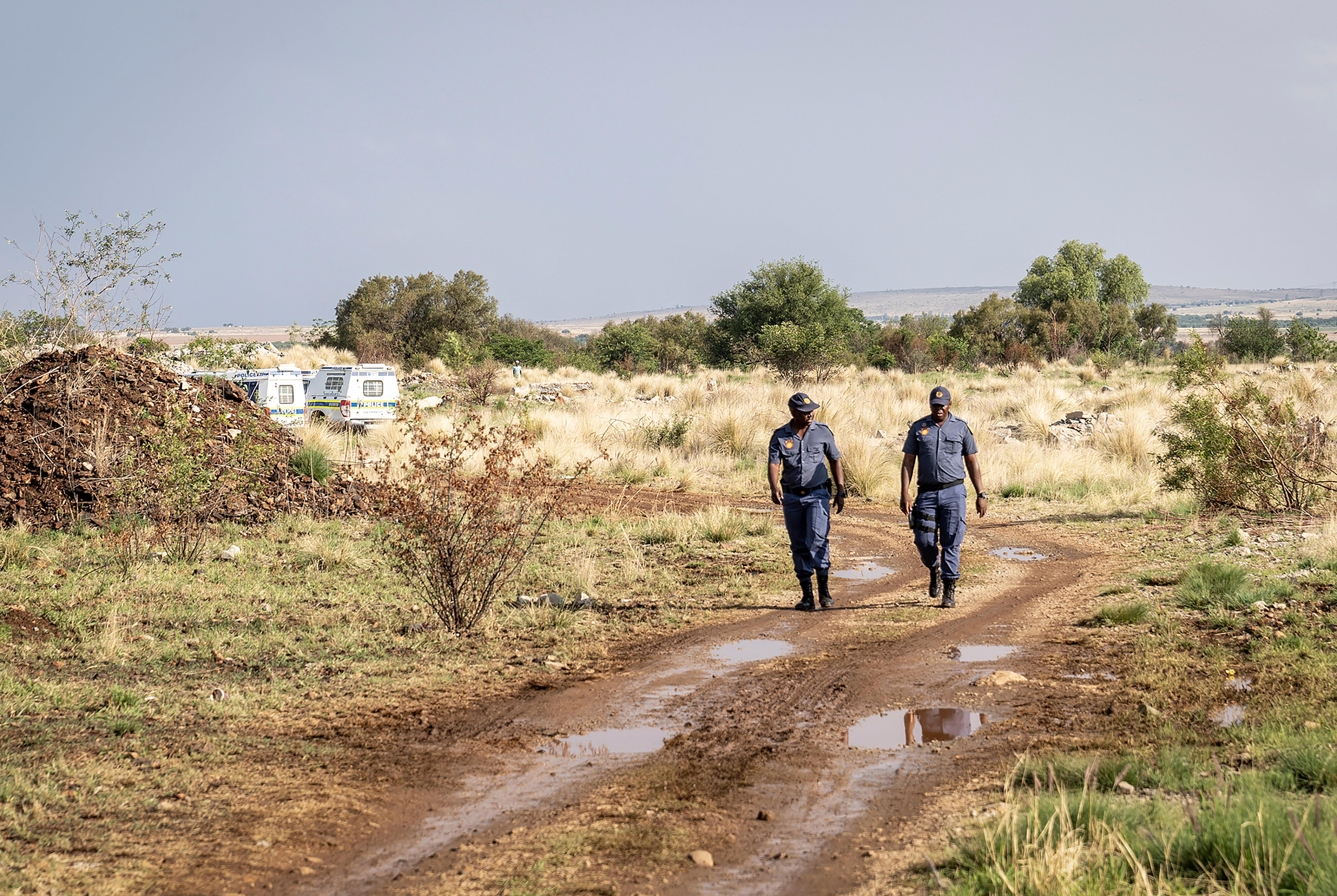 Police patrol at a mine shaft where an estimated 4000 illegal miners are trapped in a disused mine in Stilfontein