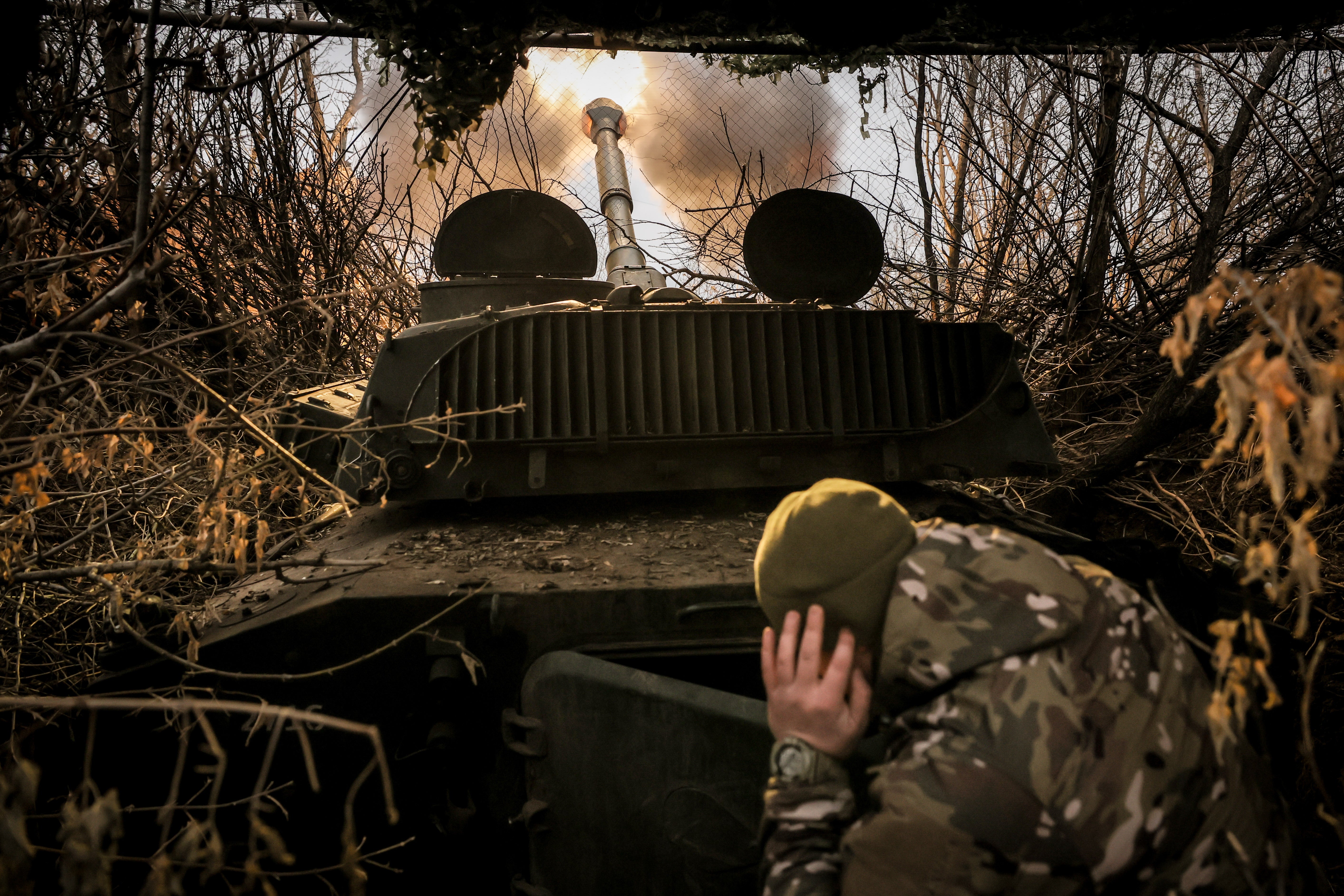 Ukrainian soldiers fire a 2S1 self-propelled 122mm howitzer towards Russian positions near Chasiv Yar, Donetsk region, eastern Ukraine