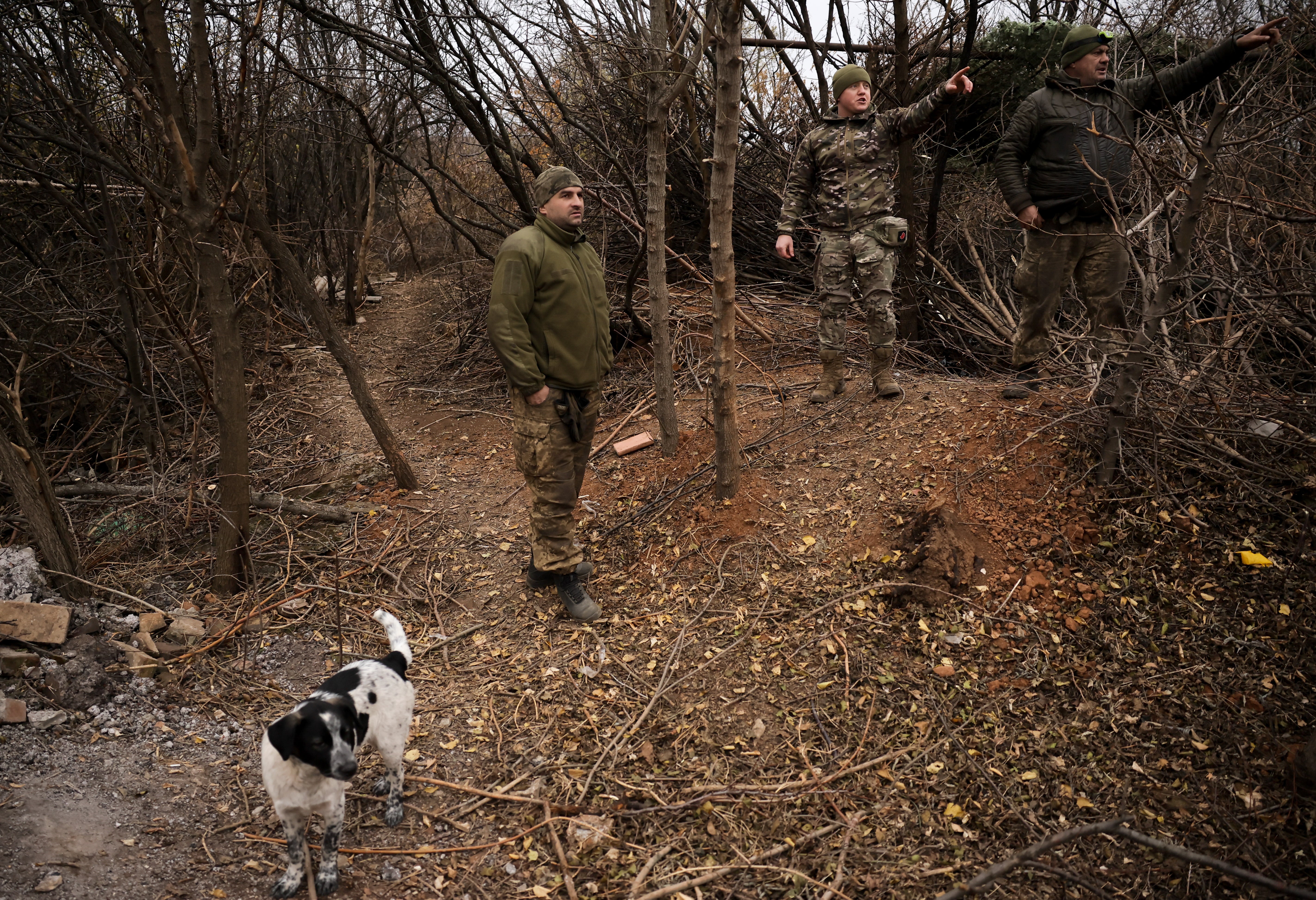 Ukrainian soldiers near Chasiv Yar are seen with a dog on the frontline