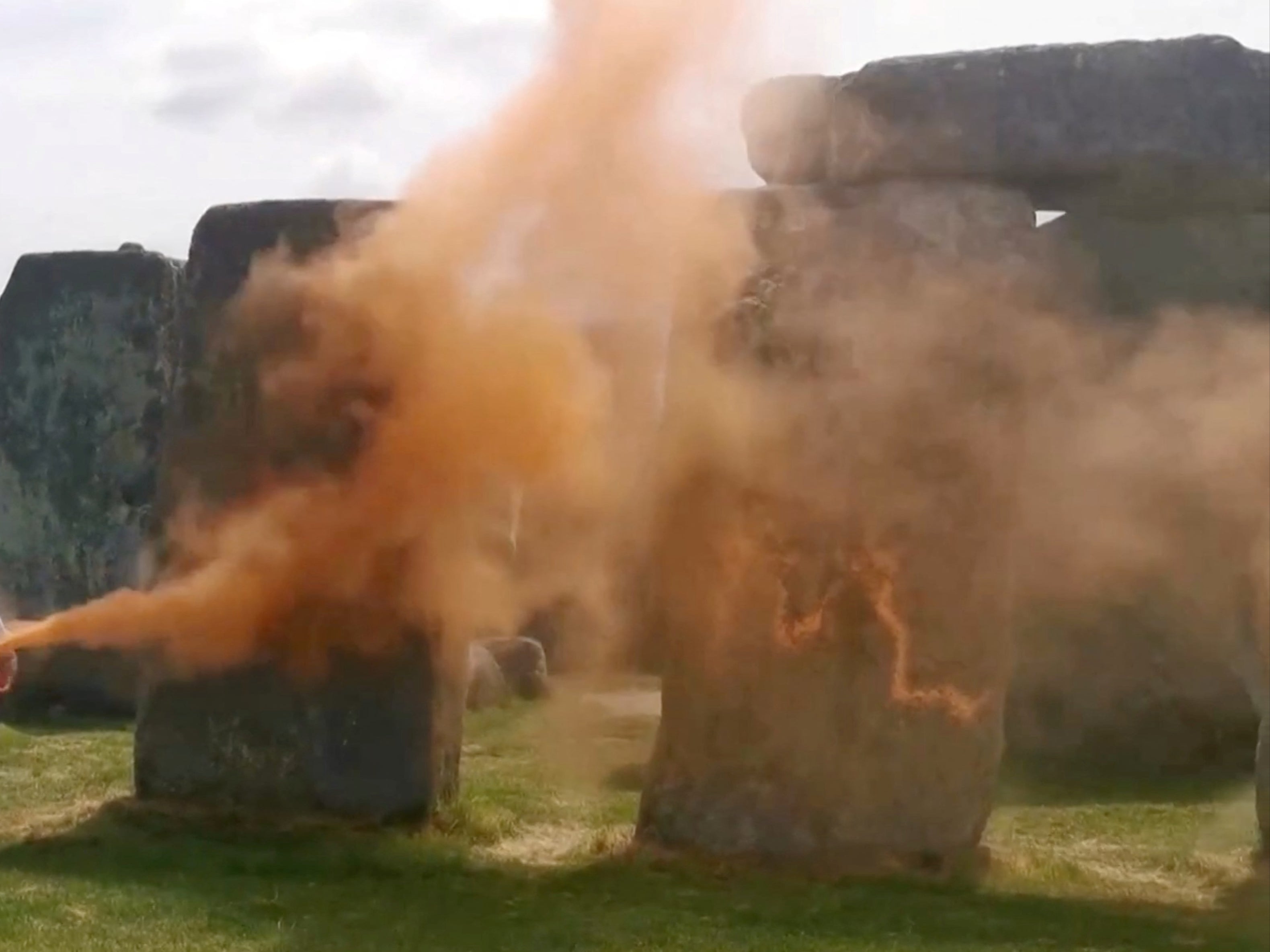 Two people have been charged after orange paint powder was sprayed on Stonehenge on 19 June