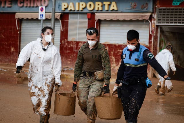 <p>Police, military and volunteers continue with cleaning operations in the flood-hit municipality of Paiporta</p>