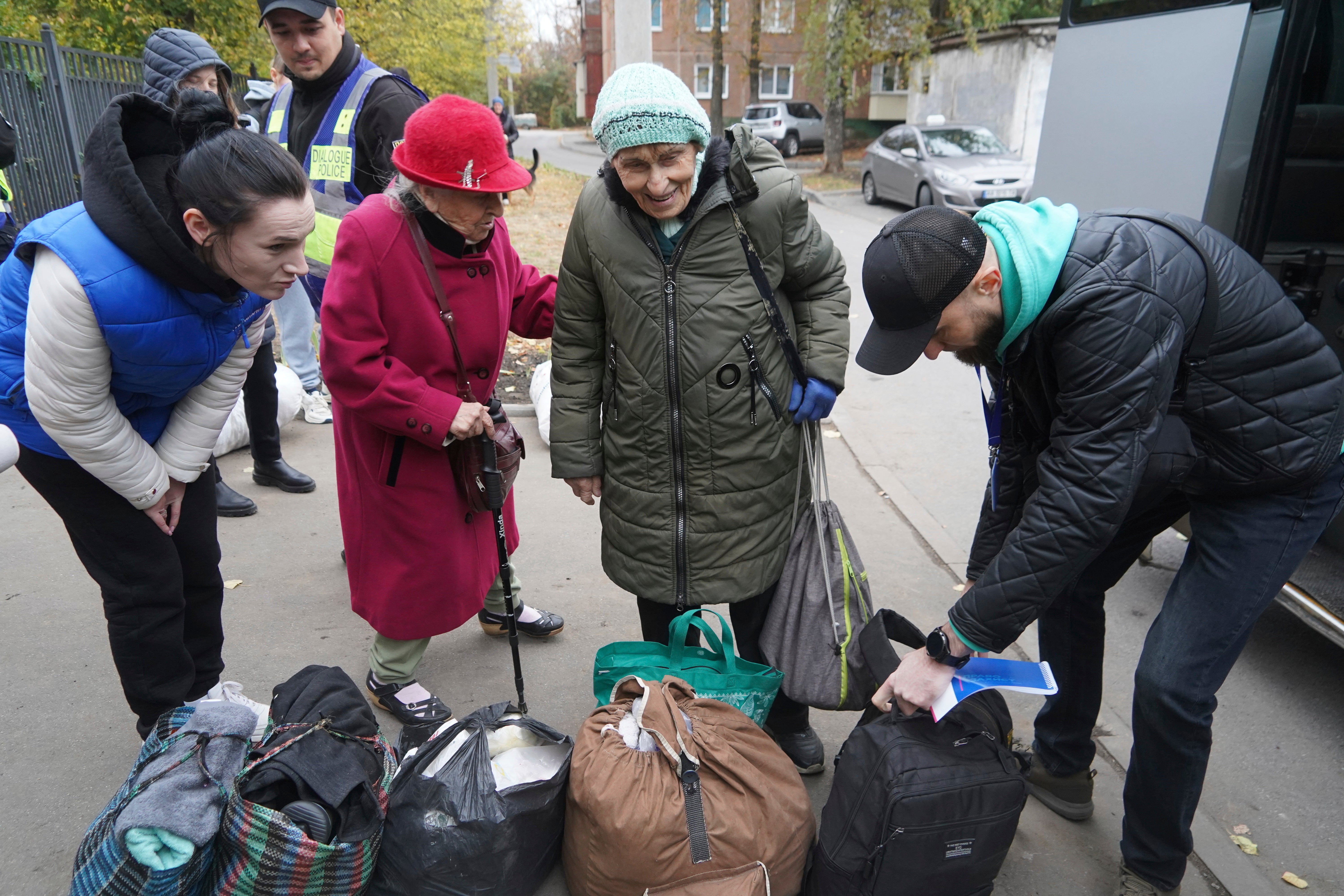 Elderly women receive their possessions after being evacuated from Kupiansk, at a distribution center for internally displaced persons, in Kharkiv, Ukraine