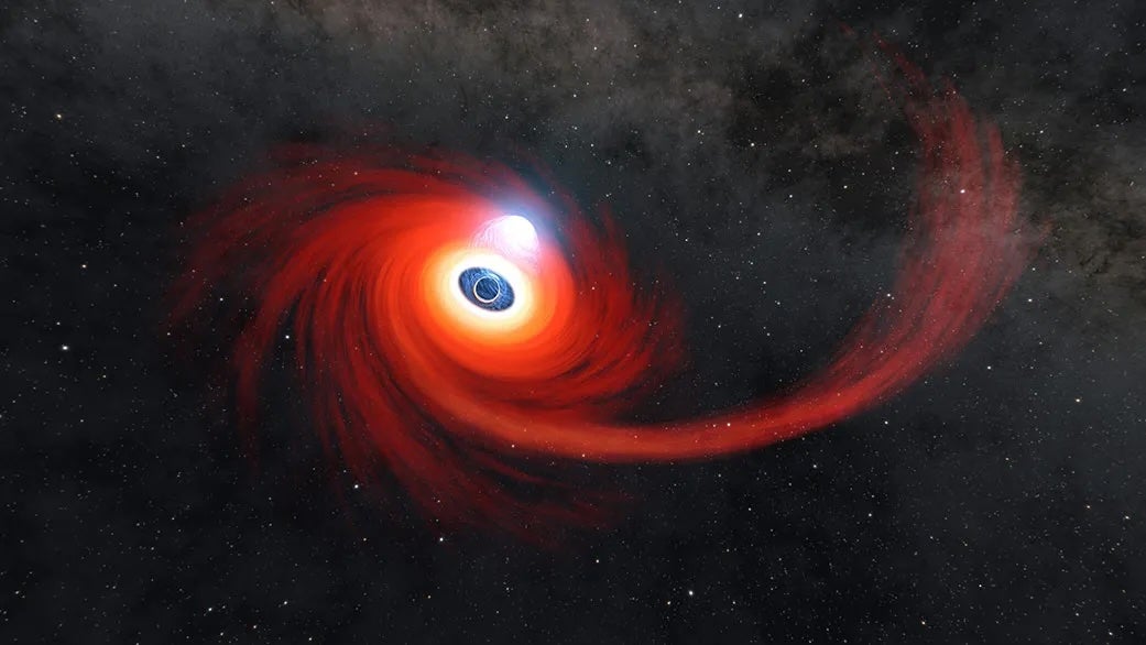 A disk of hot gas swirls around a black hole in this illustration. The stream of gas stretching to the right is what remains of a star that was pulled apart by the black hole. A cloud of hot plasma (gas atoms with their electrons stripped away) above the black hole is known as a corona.