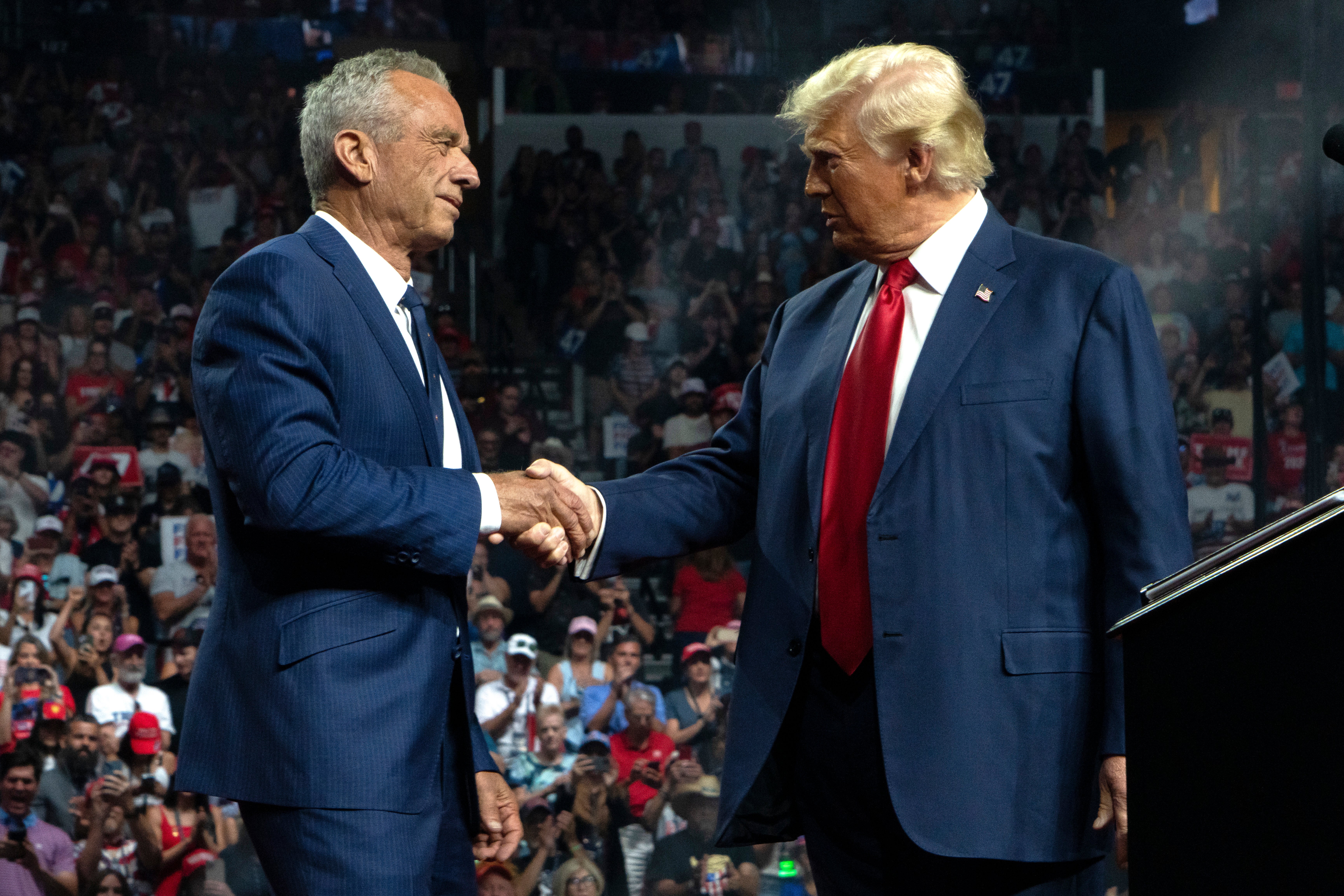 Former Republican presidential candidate Robert F. Kennedy Jr. and Republican presidential nominee, former U.S. President Donald Trump shake hands during a campaign rally at Desert Diamond Arena on August 23, 2024 in Glendale, Arizona